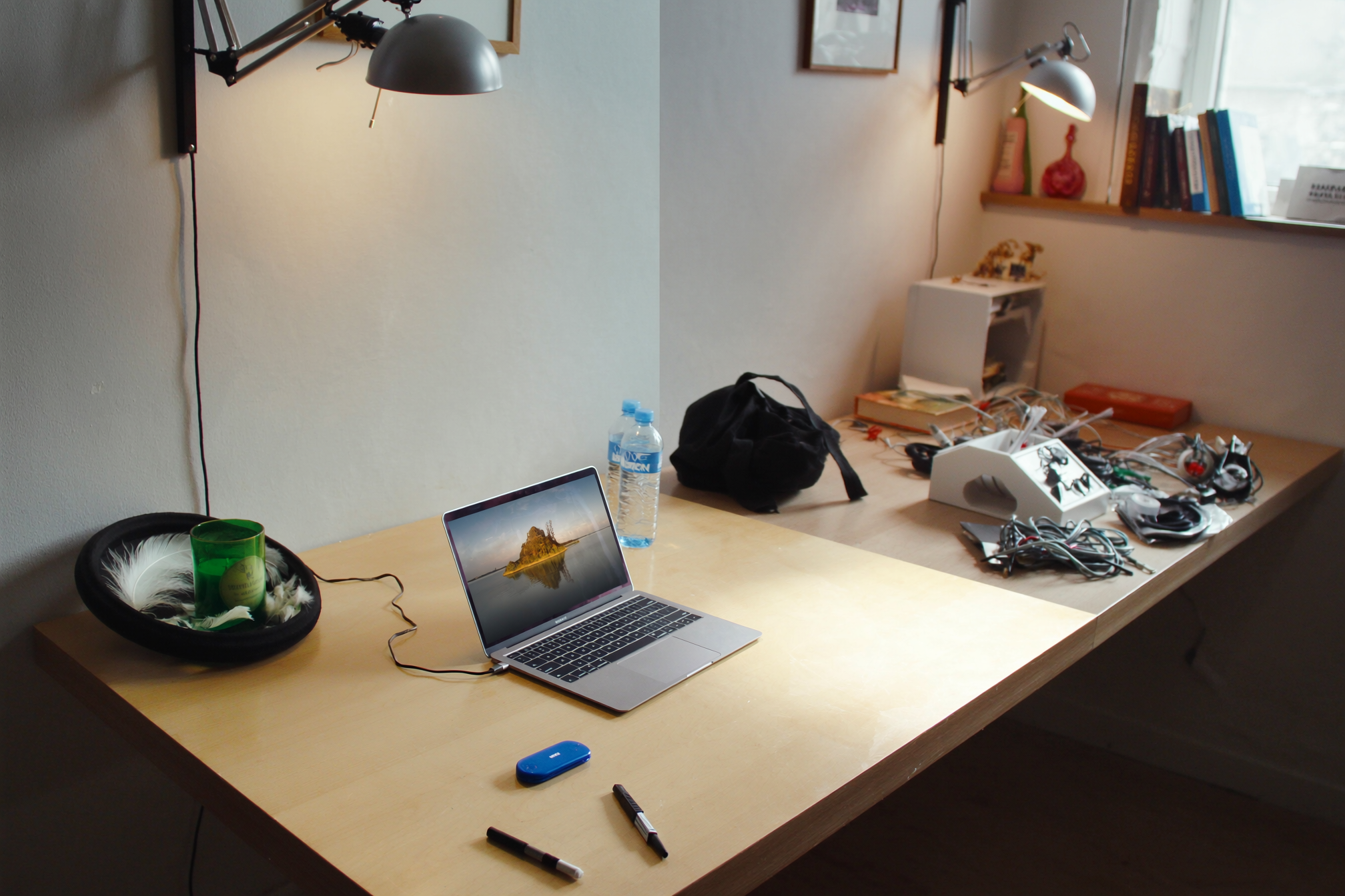 Small desk being organized to reduce clutter