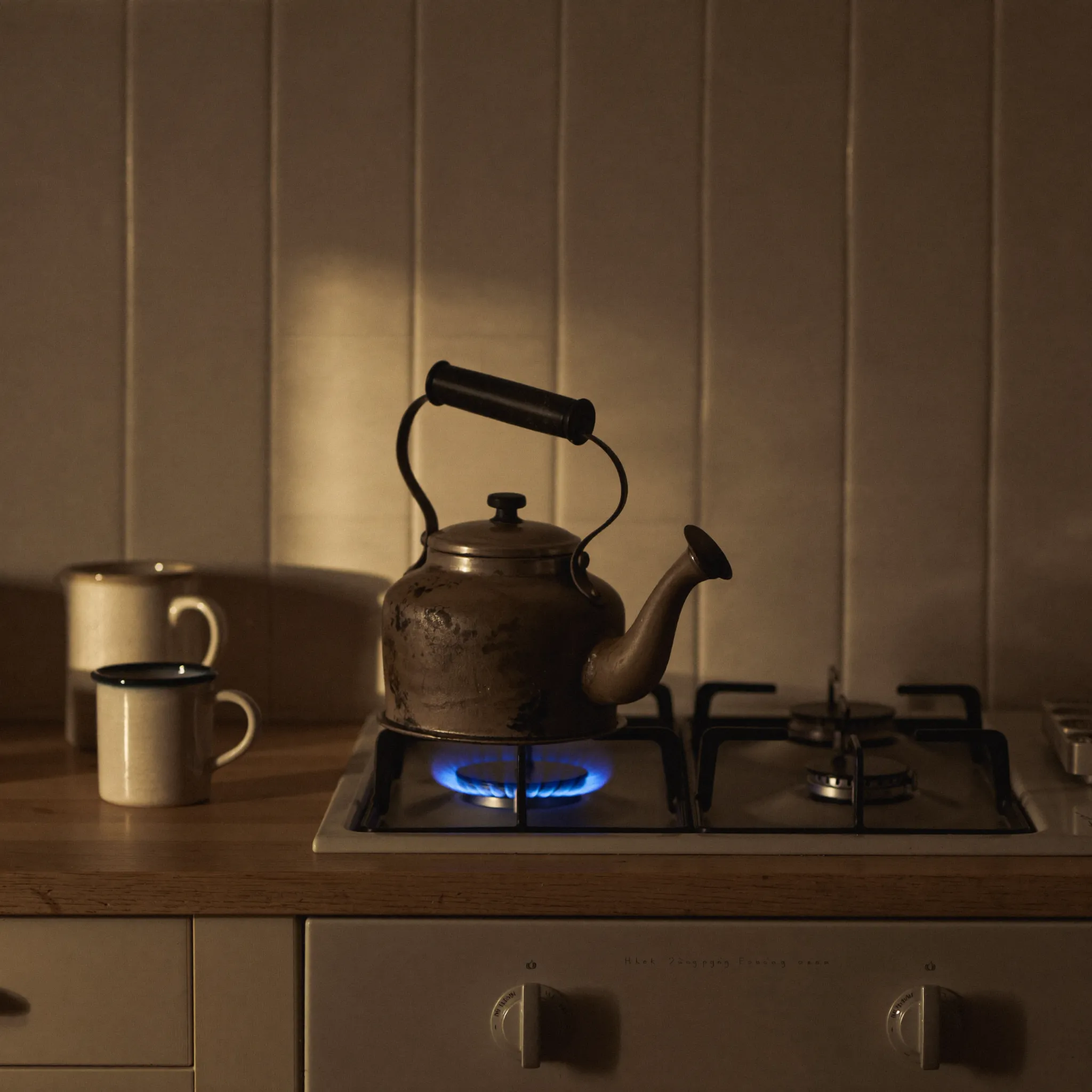 Kettle steaming on the stove in a warm kitchen