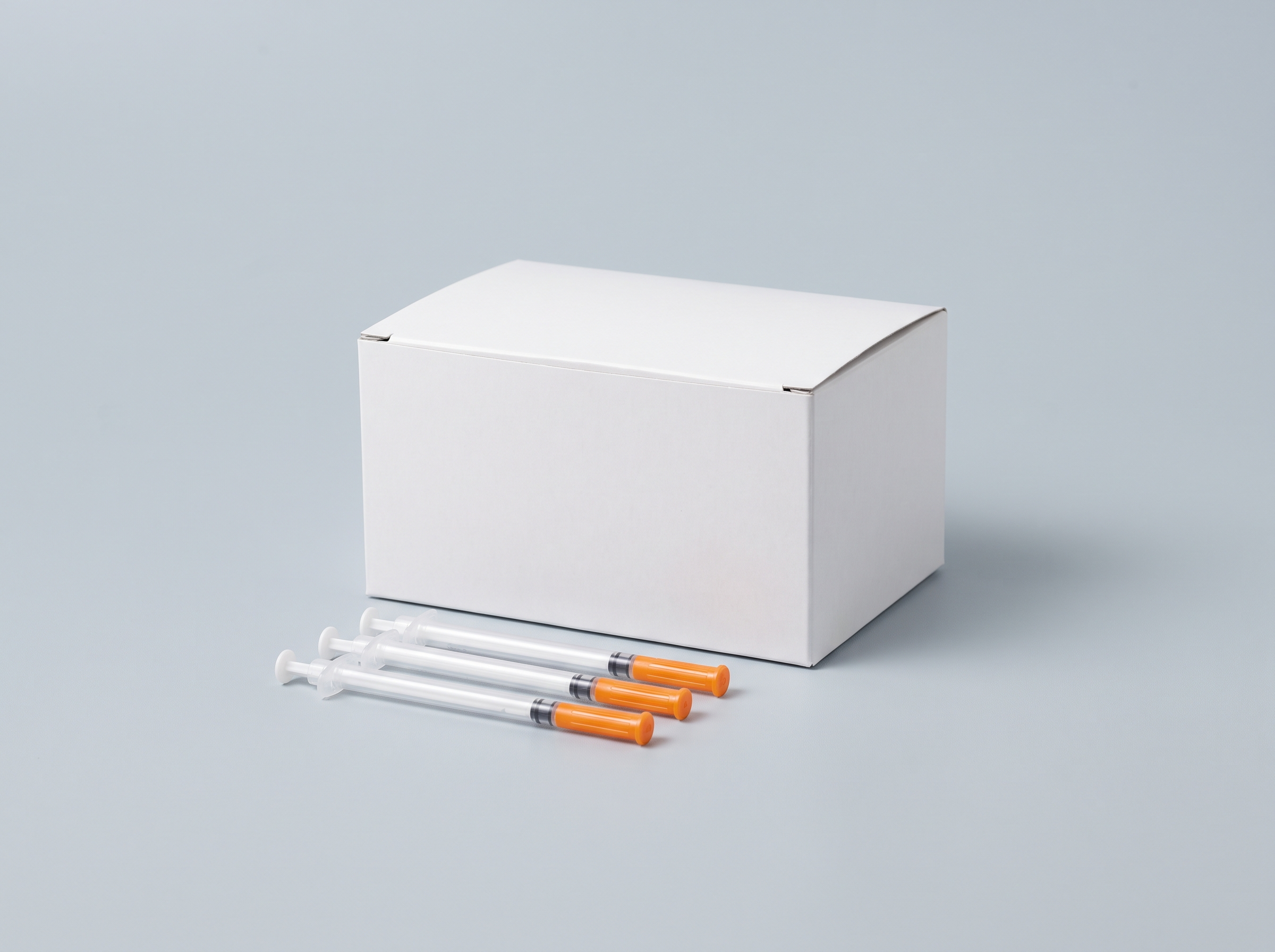 A box of insulin syringes with three laid in front
