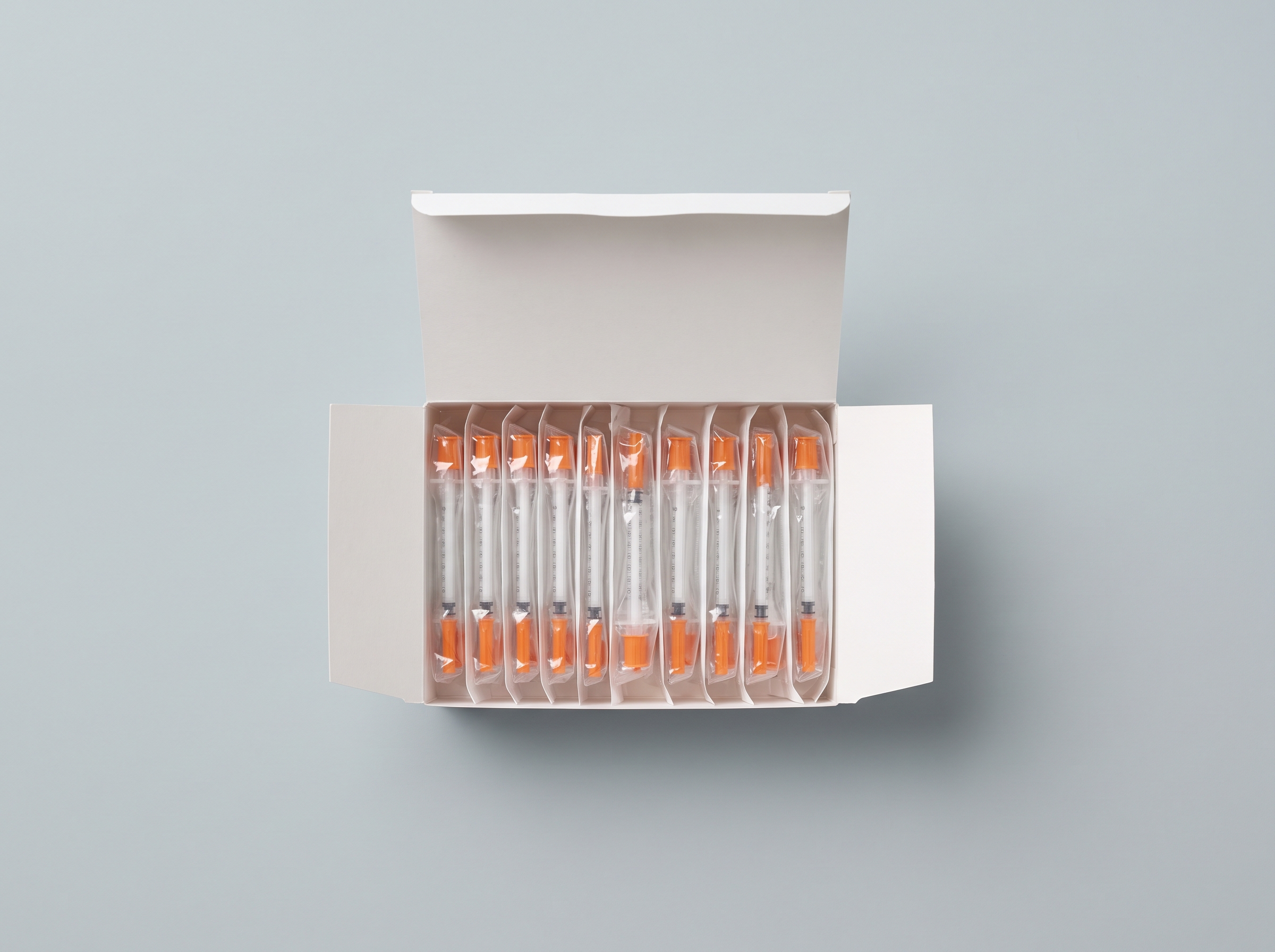 An open carton of supplies with blister-wrapped rows inside