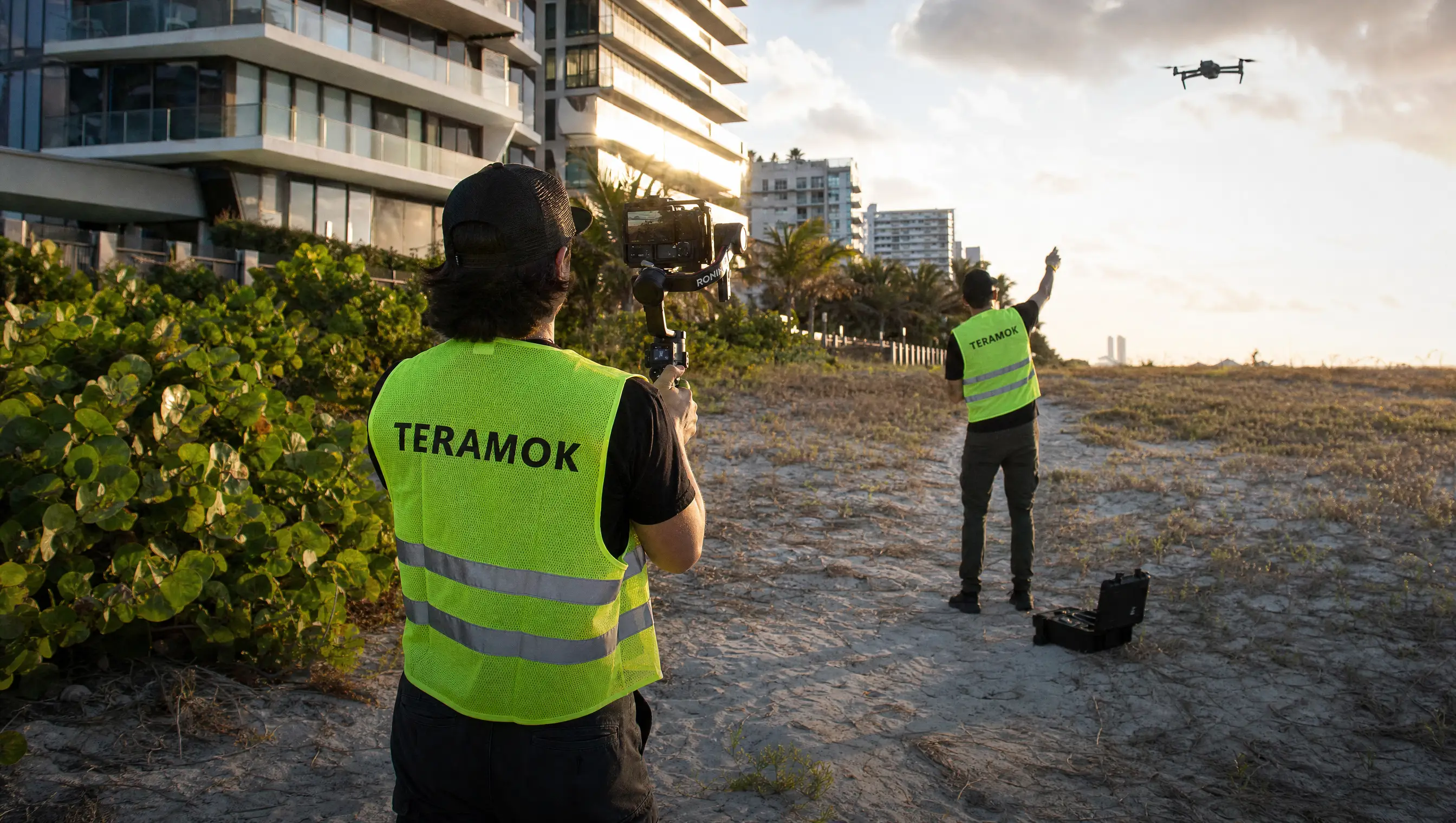 TERAMOK film crew with a gimbal and drone at a Miami Beach condo tower at golden hour, real estate photographer in Miami