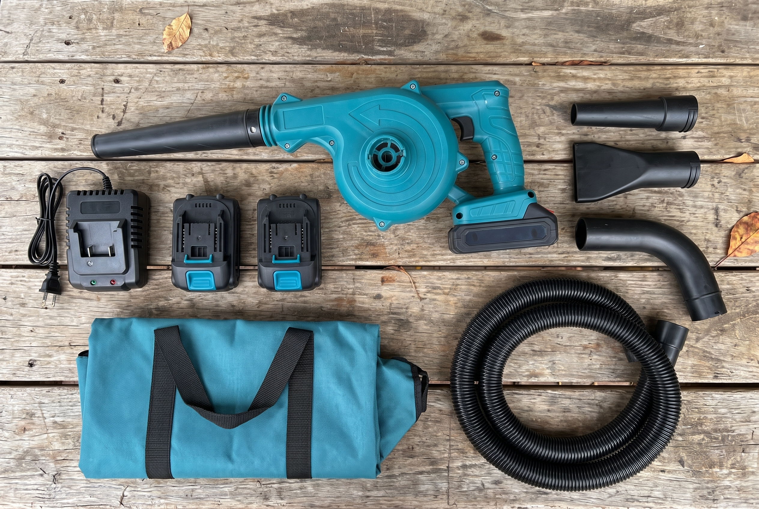 The full leaf blower kit laid out: blower, 2 batteries, charger, nozzles, bag and hose