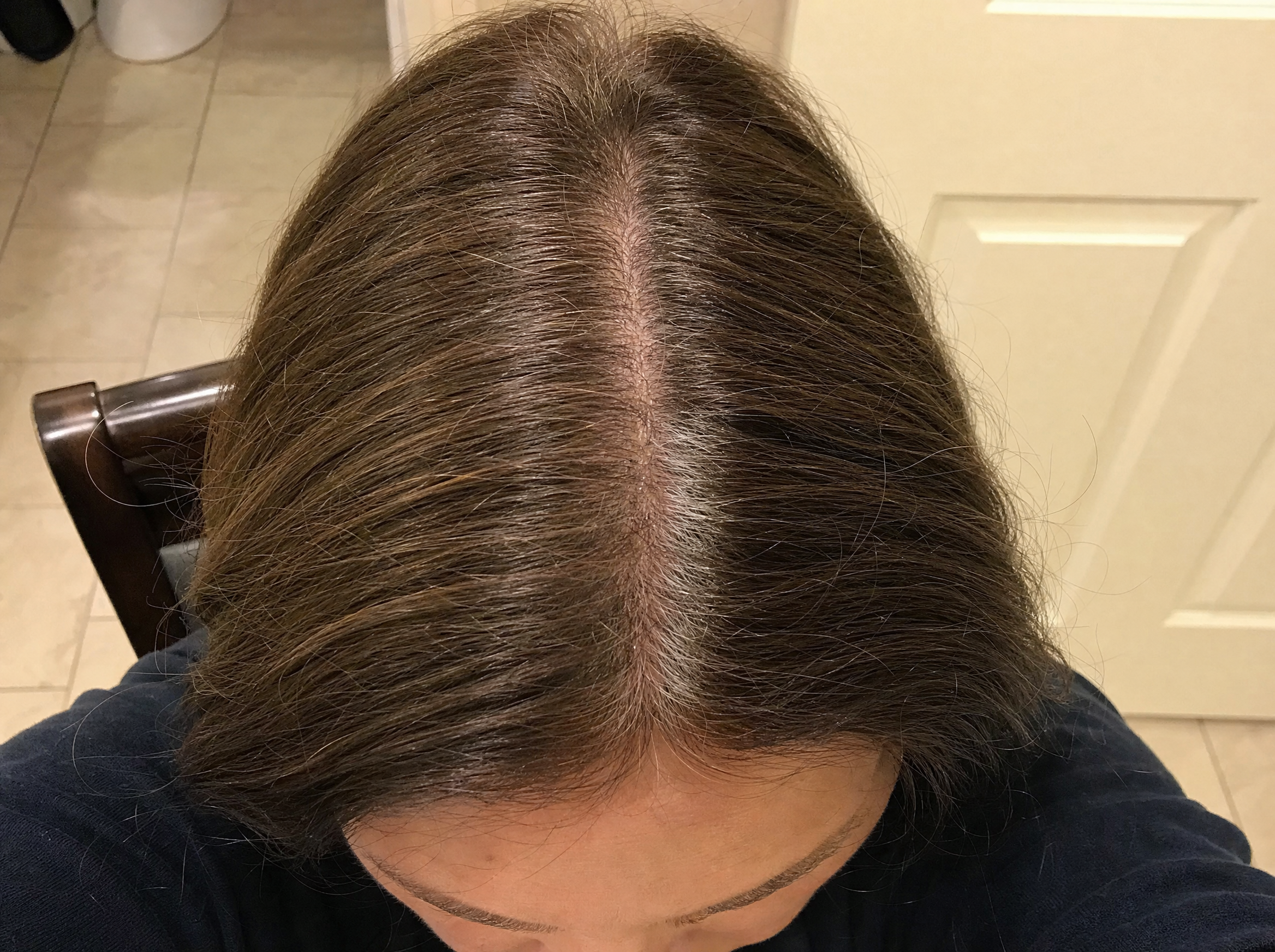 Illustrative single phone photo of a center hair part for consistent tracking