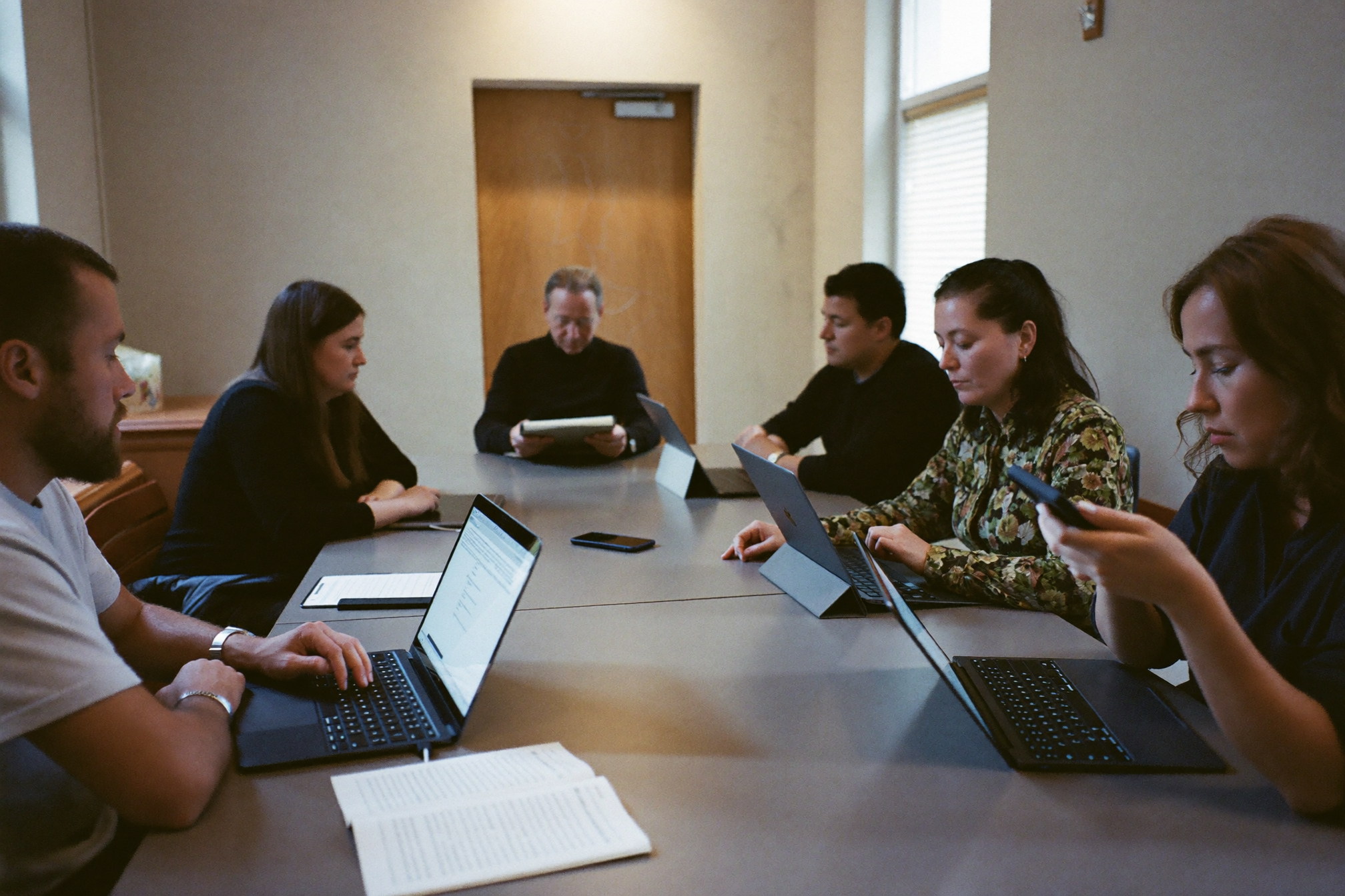 A small group around a church conference table looking at a single page