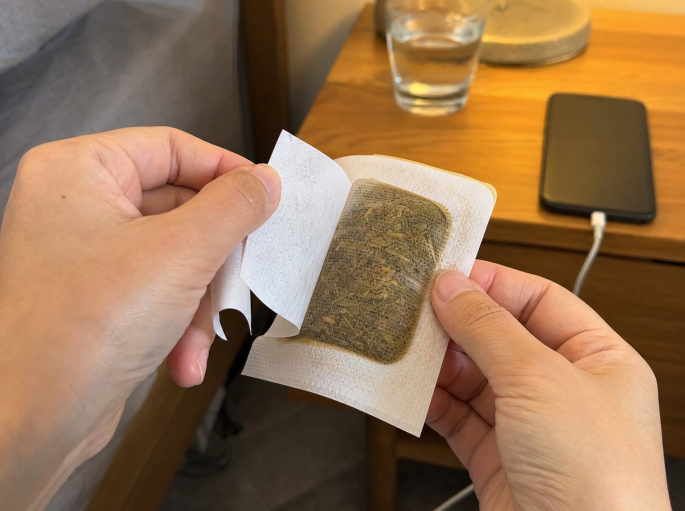 Hands peeling Nuzzelle foot patch backing
