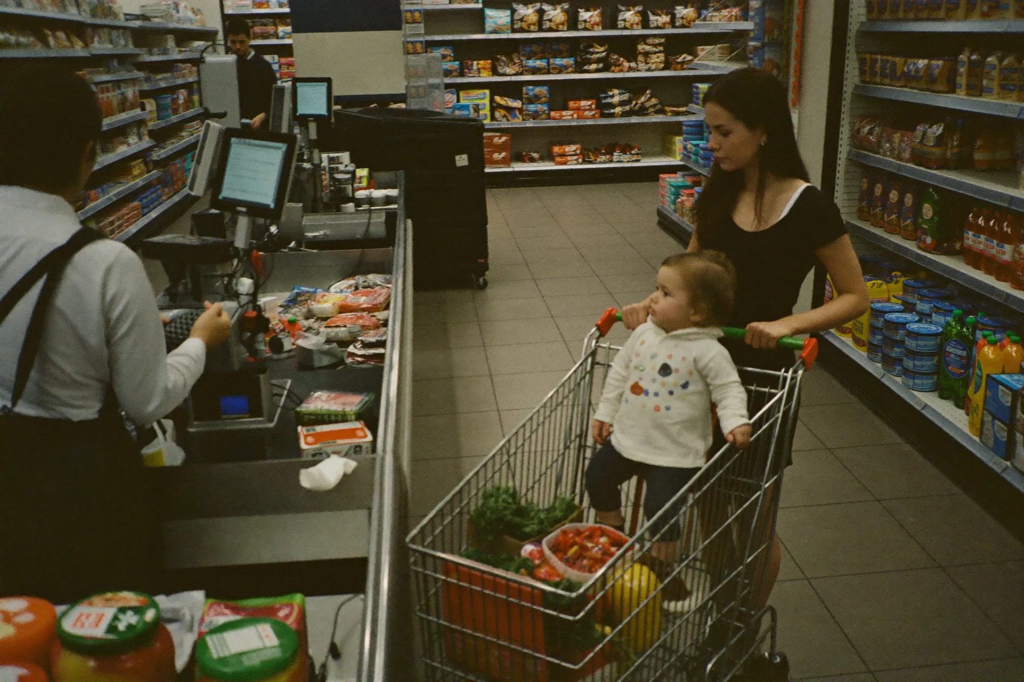 A supermarket cashier scanning groceries for a customer