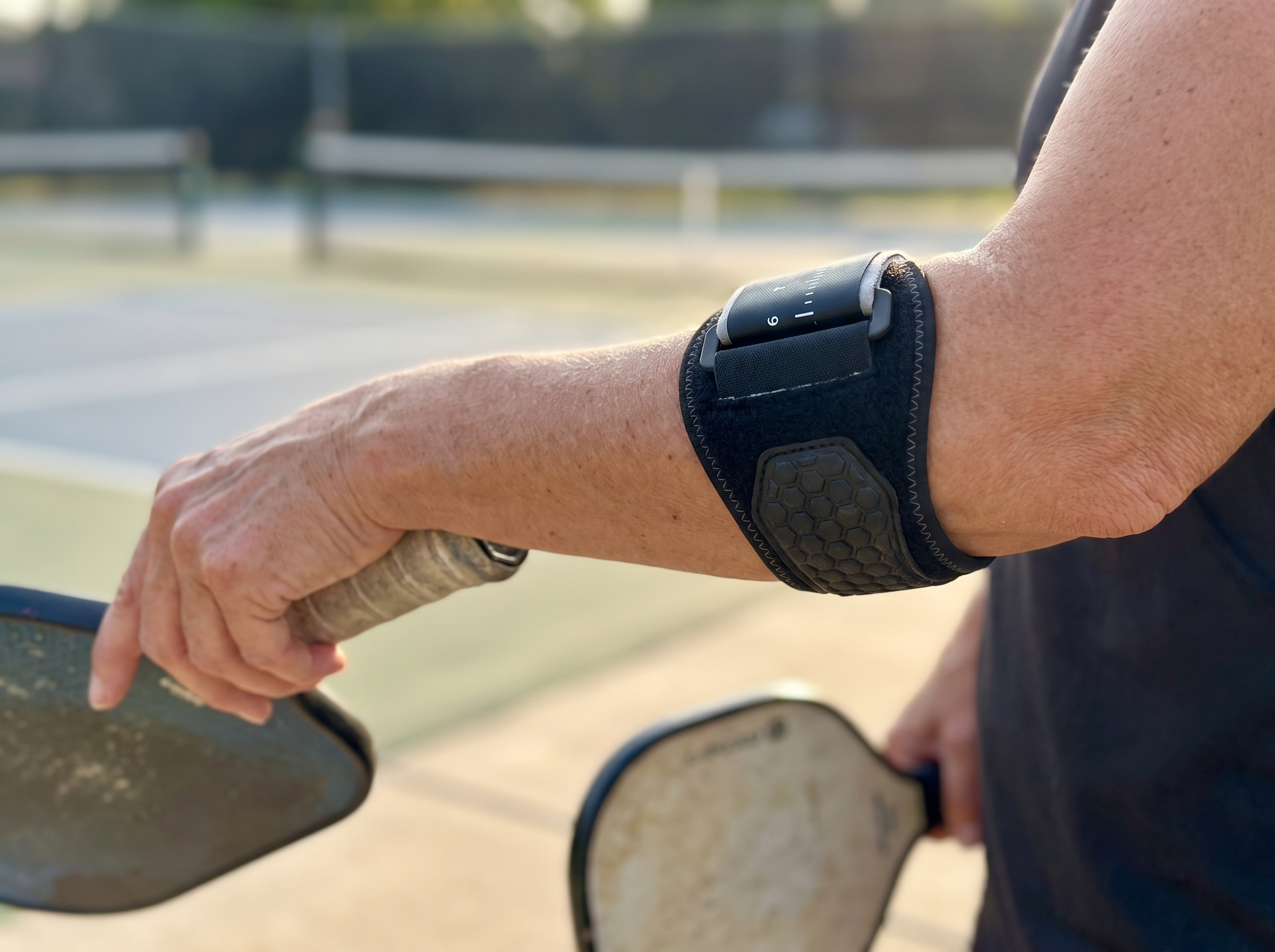 Close-up of the Rally Strap and honeycomb pad worn below the elbow