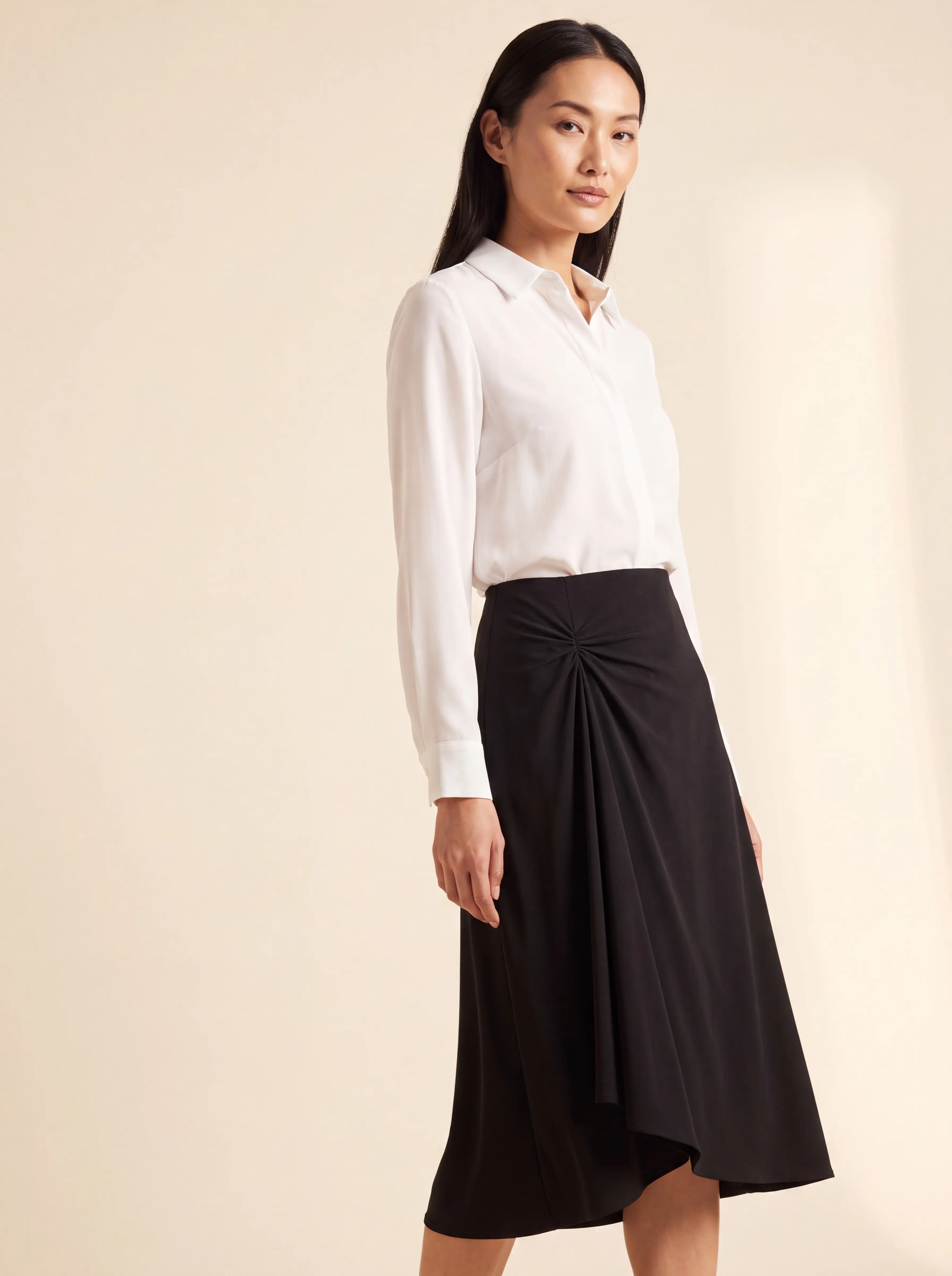 Model in a black midi skirt gathered asymmetrically with Tailor Ring