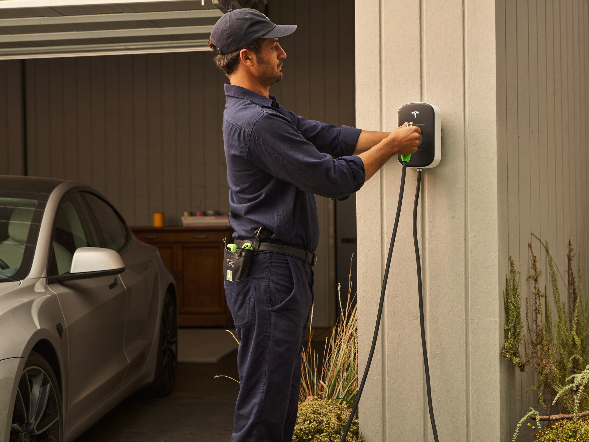 Electrician installing a Tesla Wall Connector EV charger in an Adelaide garage