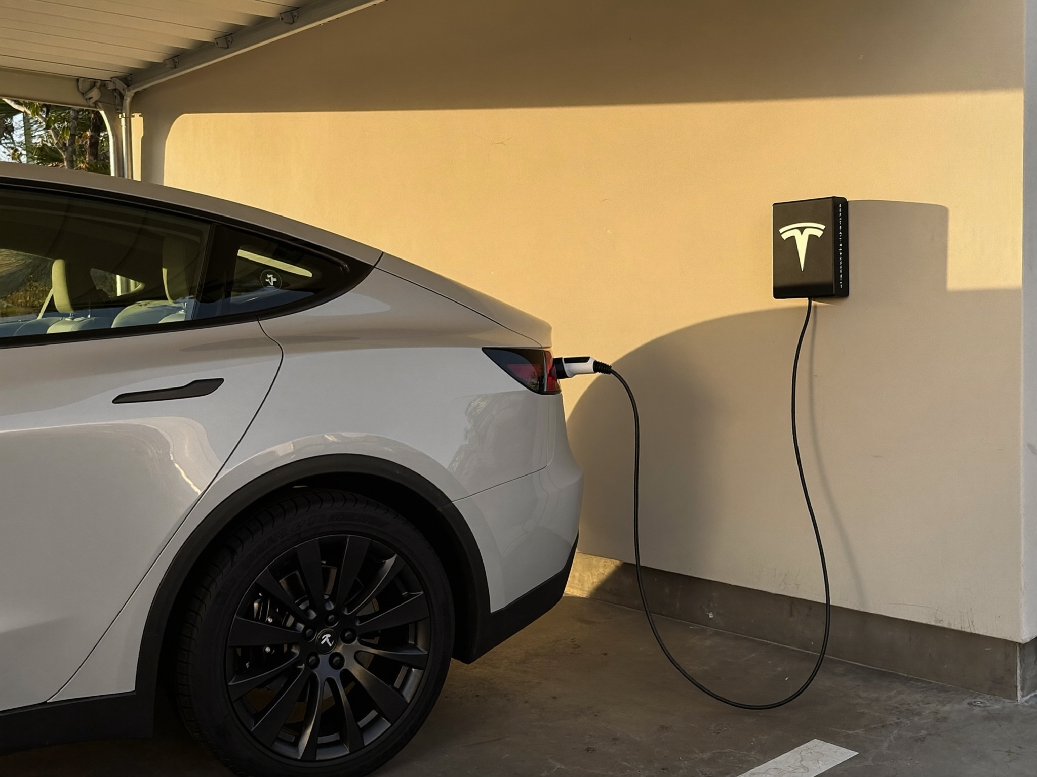 Tesla charging from a Tesla Wall Connector in an Adelaide home garage