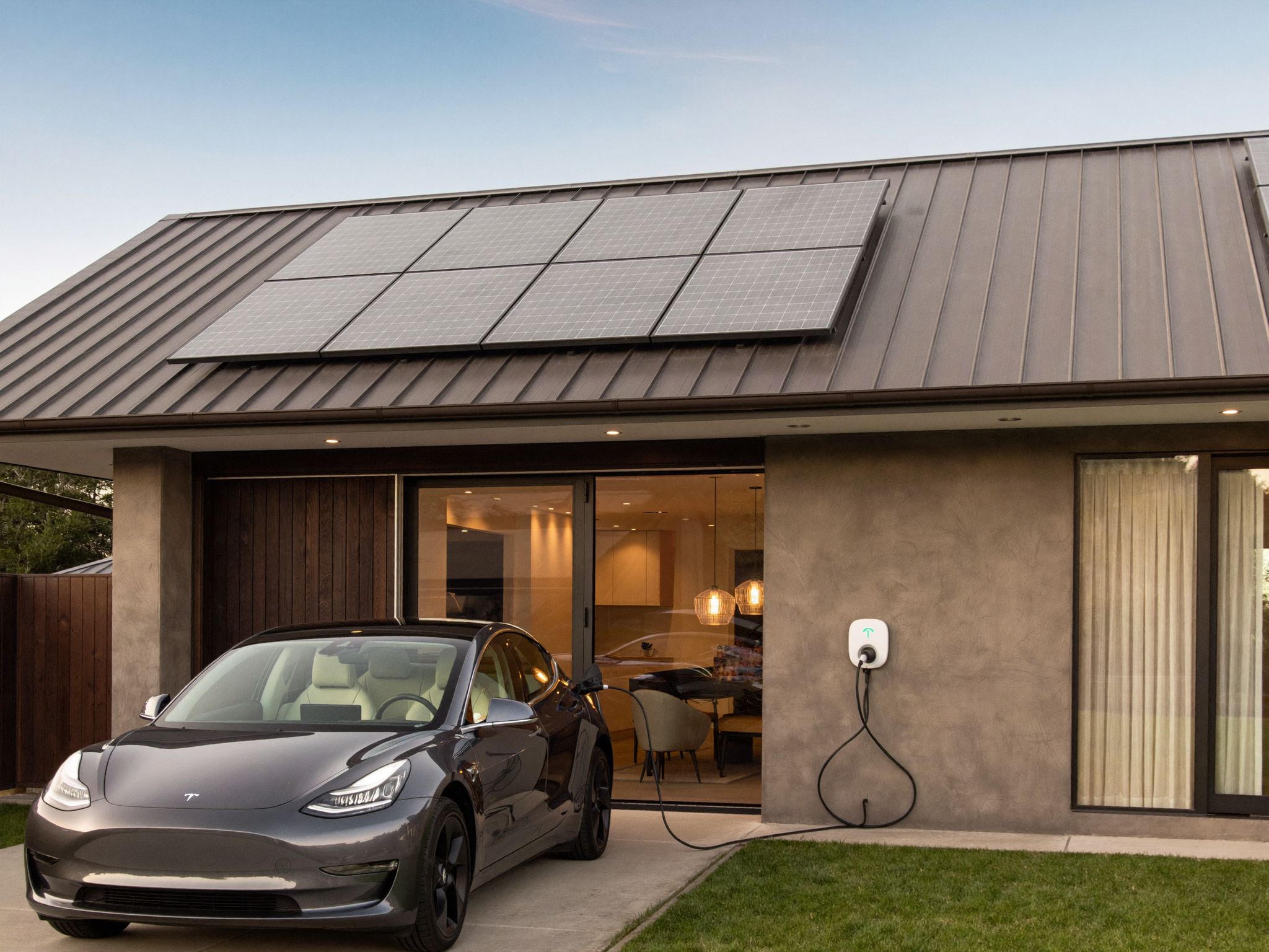 Australian home with solar panels and a Tesla charging in the driveway