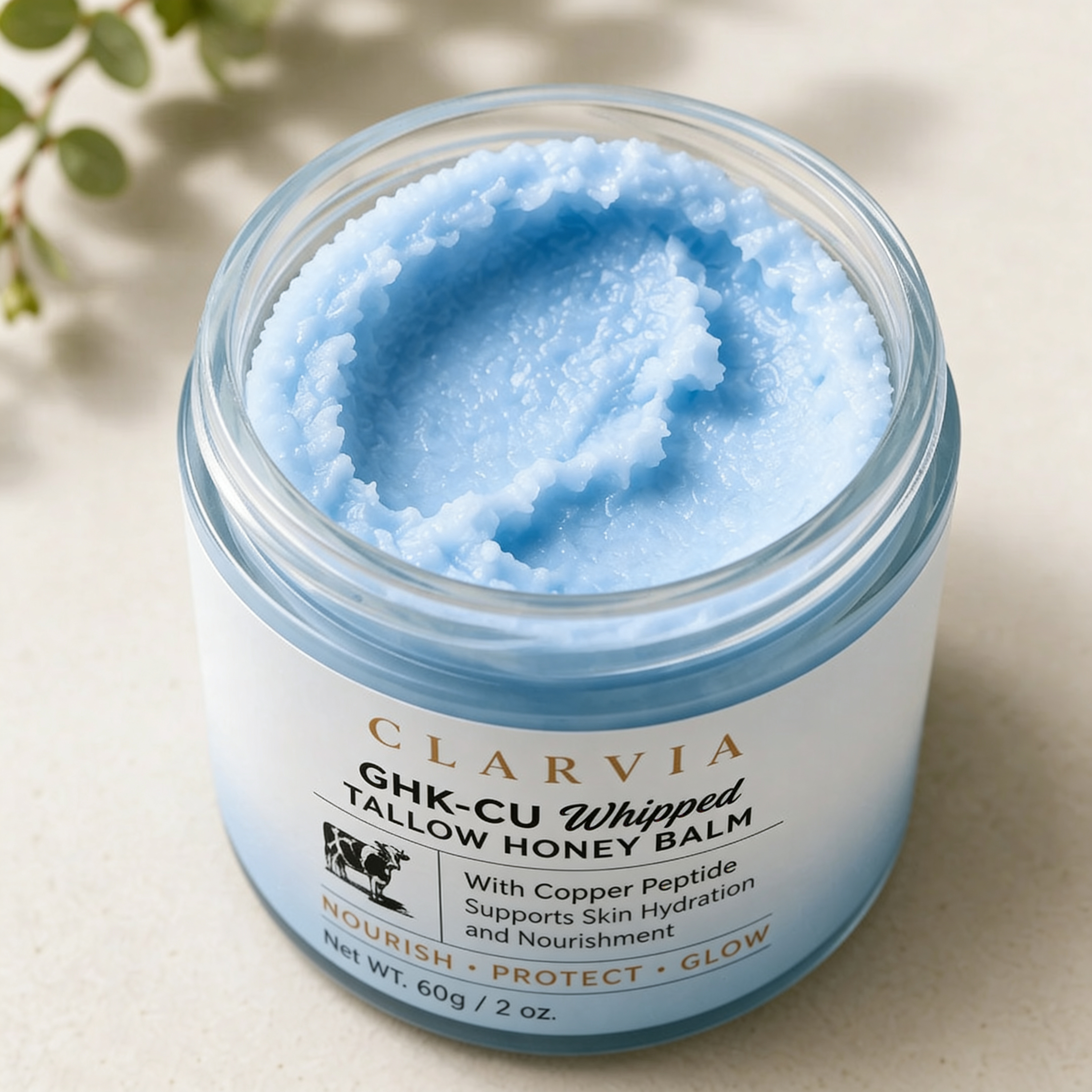 The Restoration Balm by Clarvia, the open labeled jar showing the pale blue whipped balm inside.