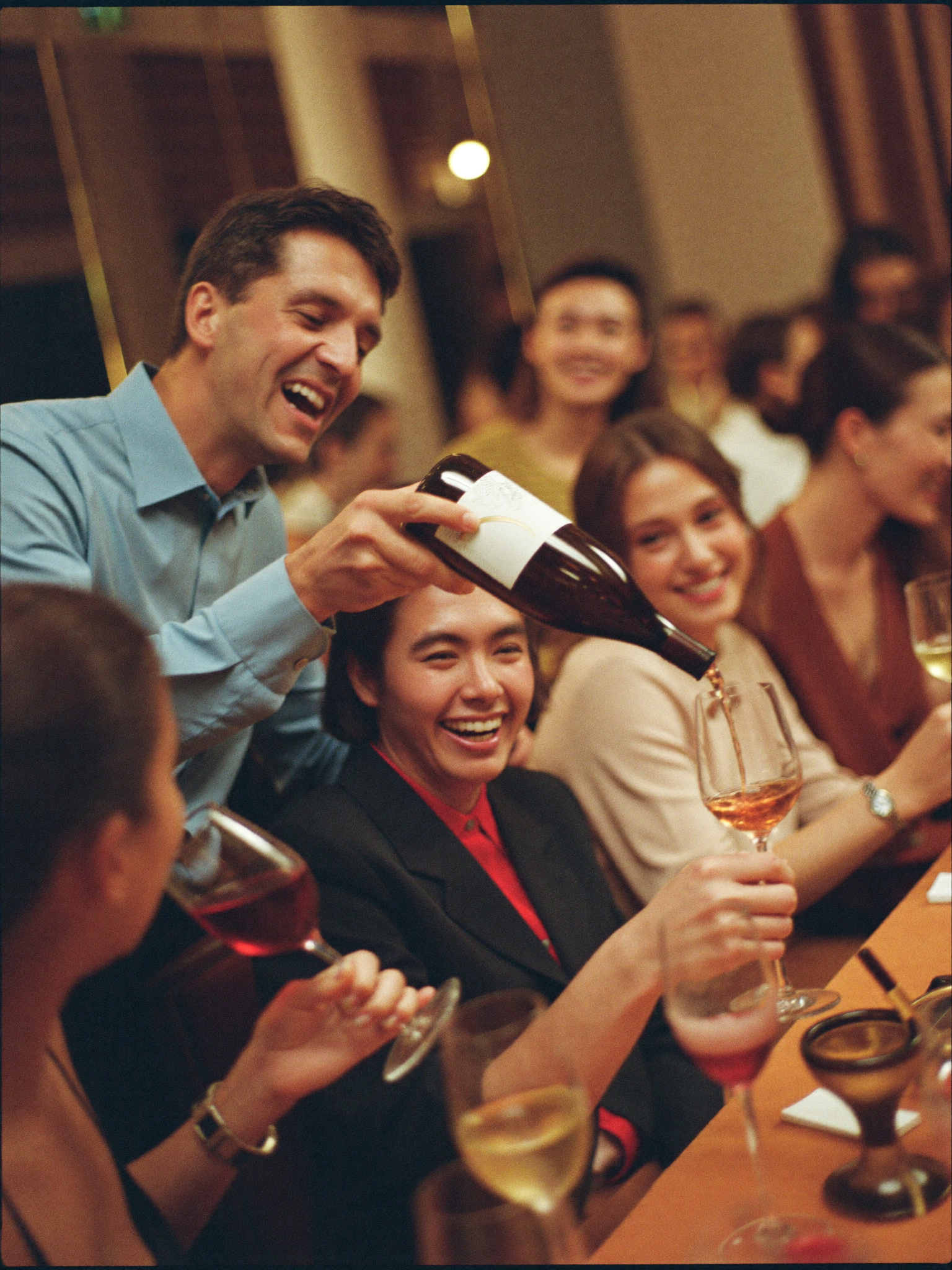 Group of professionals at a guided wine tasting led by a host