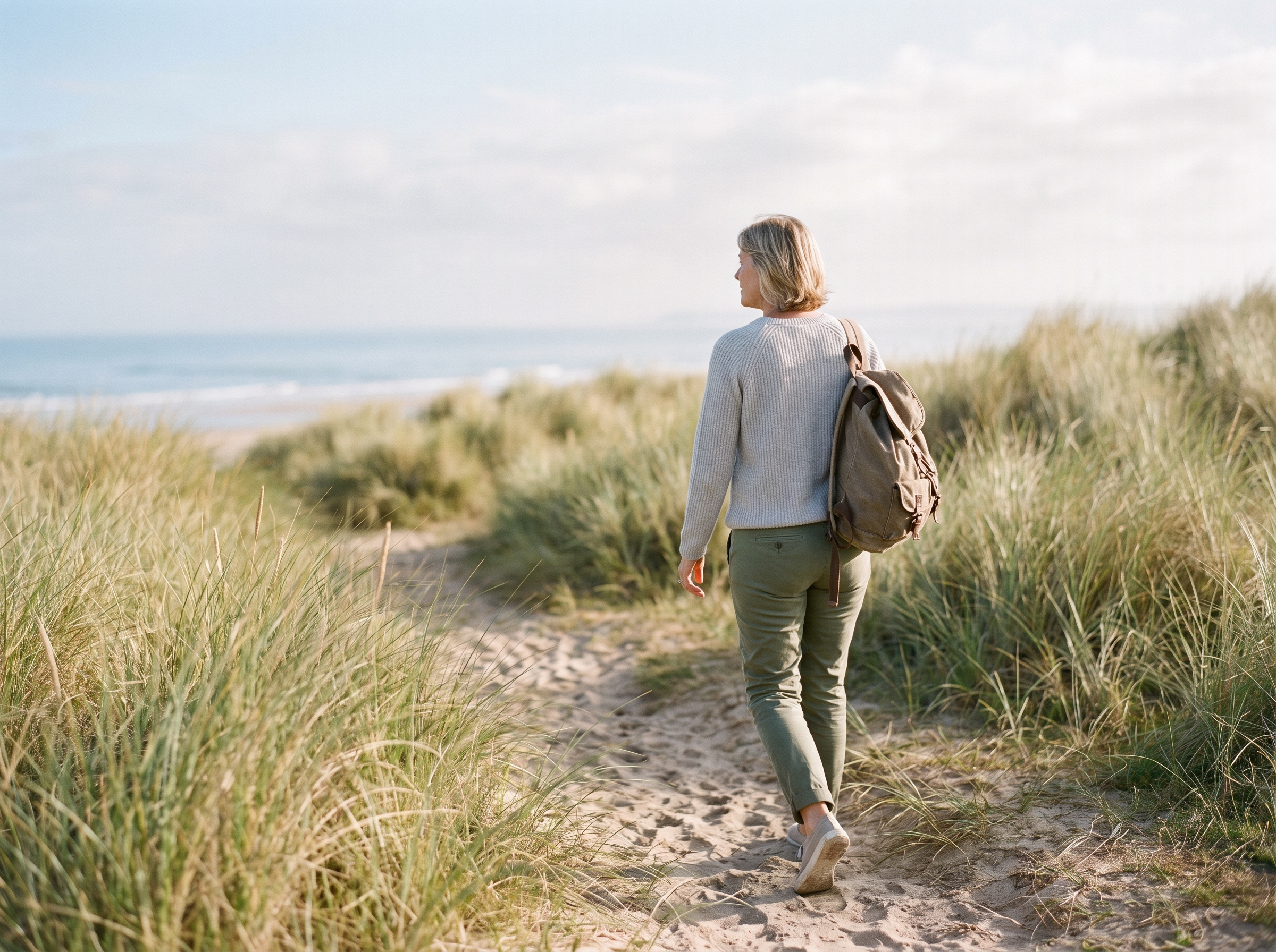 An adult walking easily and confidently in natural morning light — restored stability and personal capacity