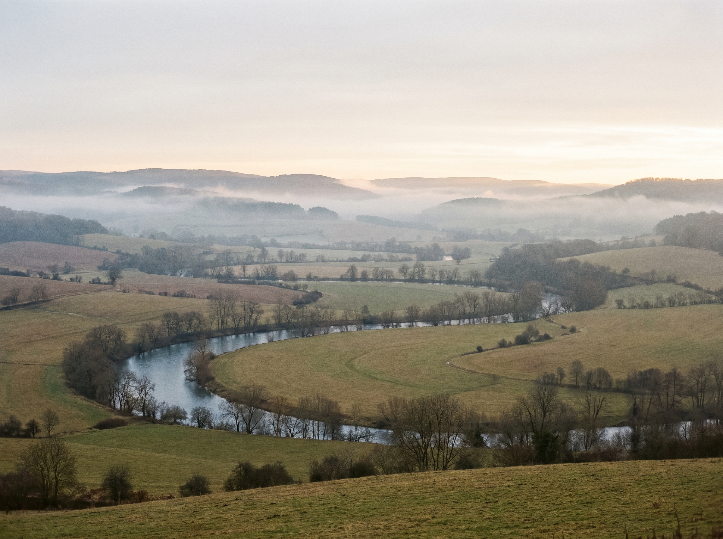 A slow river winding through a valley at dawn — seeing the fuller pattern of the conditions beneath the response