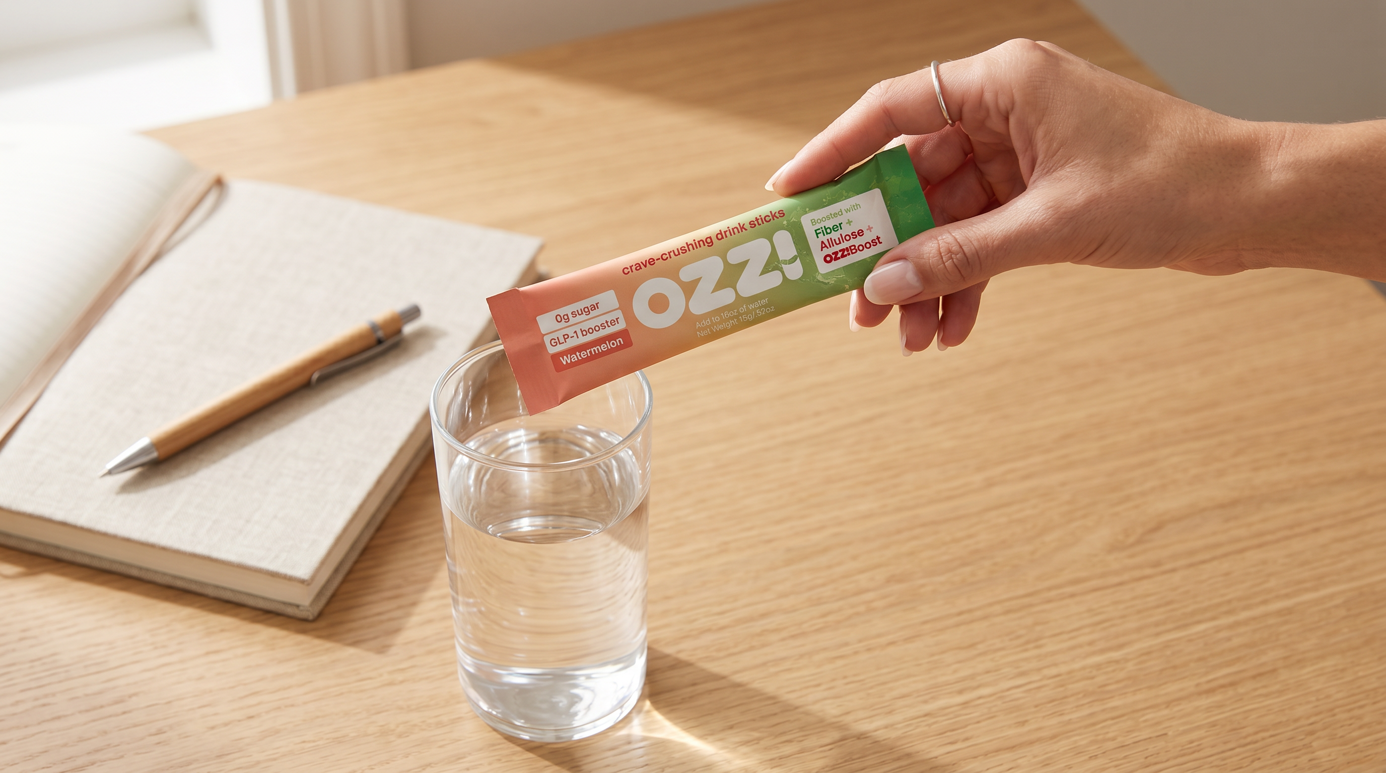Hand holding an Ozzi watermelon stick pack