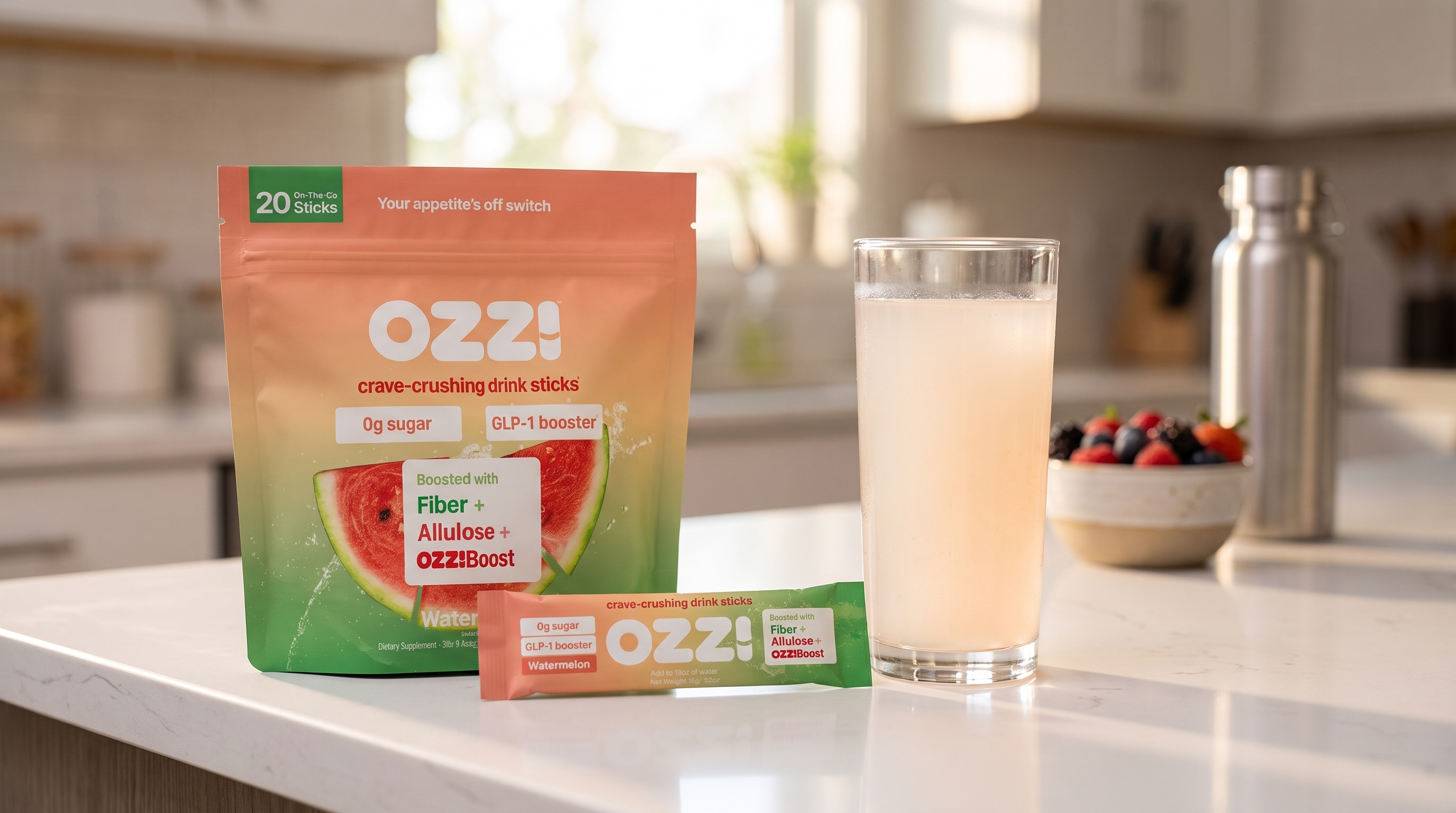 Ozzi watermelon pouch, a single stick pack, and a glass of the prepared cloudy off-white drink on a bright kitchen counter