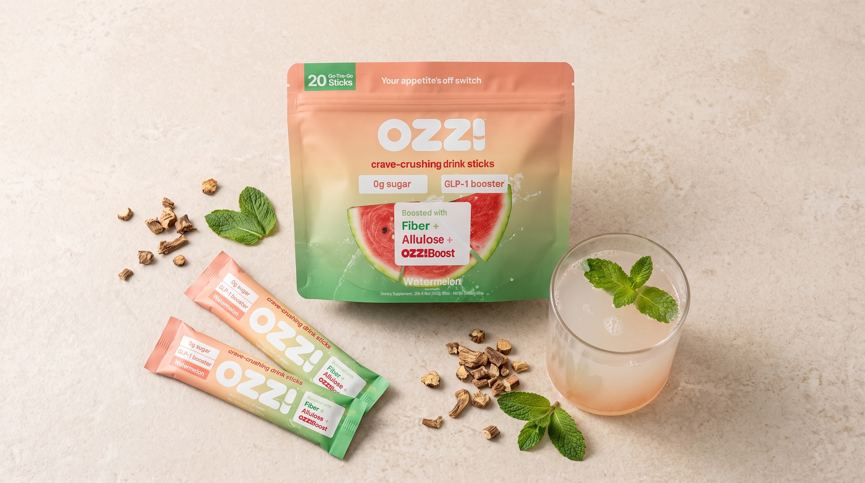 Overhead flat lay of the Ozzi pouch, two stick packs, and a glass of the prepared drink on a stone countertop