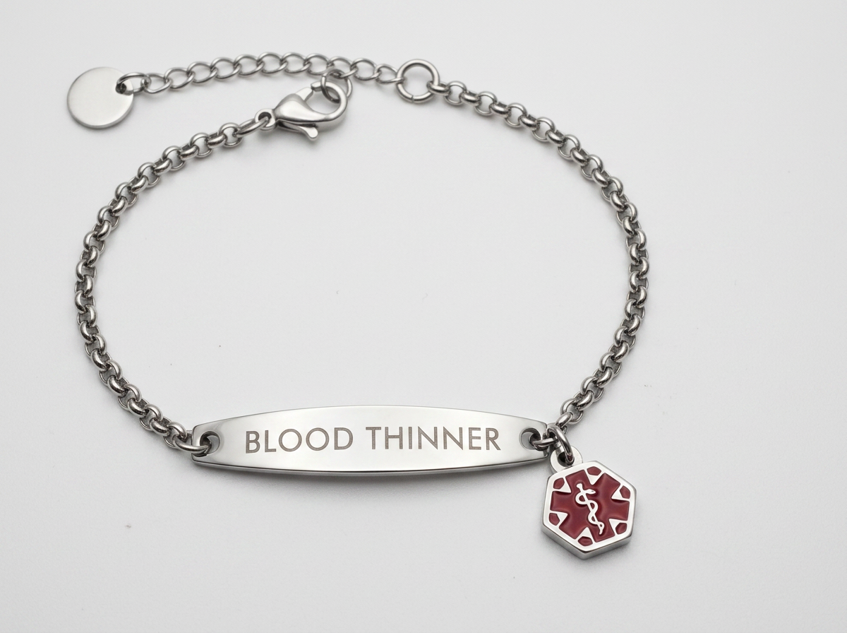 The Wrist-Check Bracelet photographed flat and dead-on, the BLOOD THINNER engraving fully legible