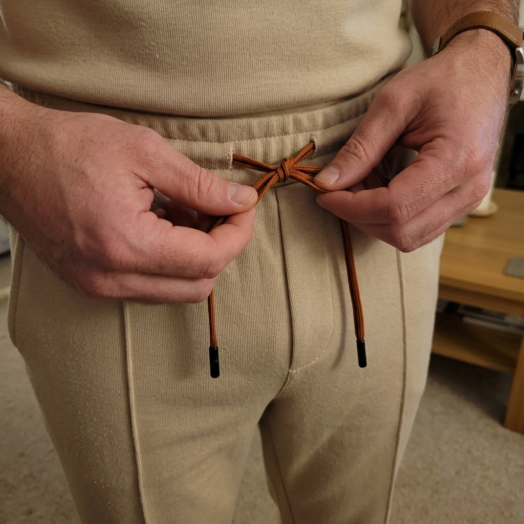 Customer tying The Cadence Set trousers