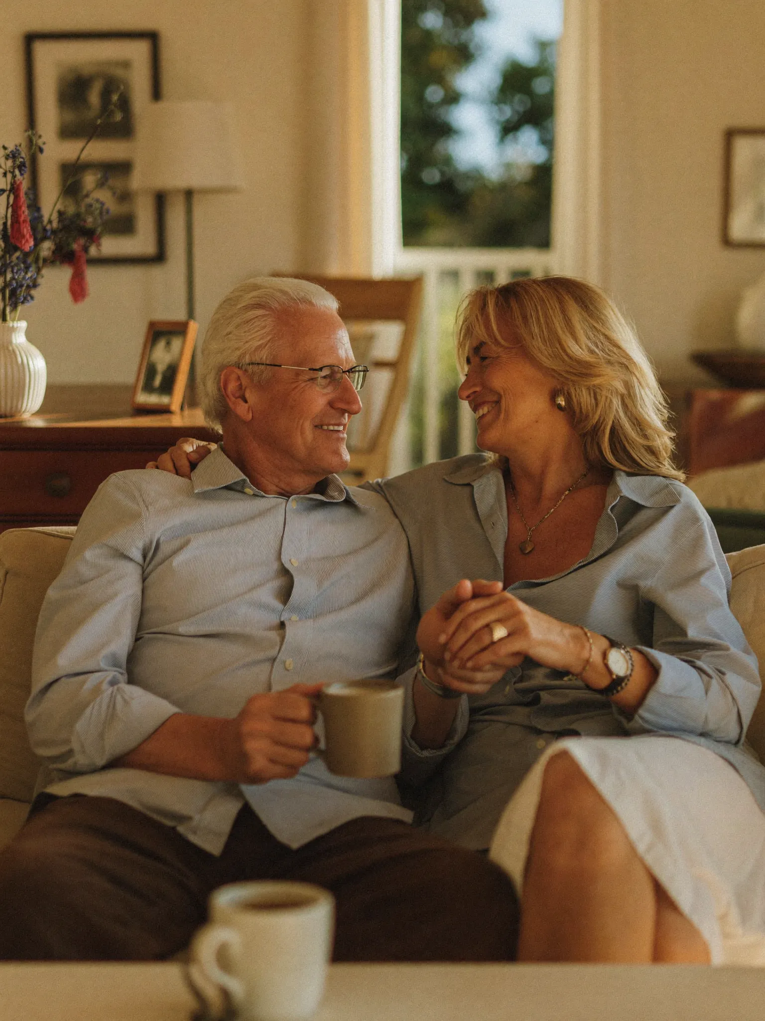 Senior couple relaxing together in their sunlit living room