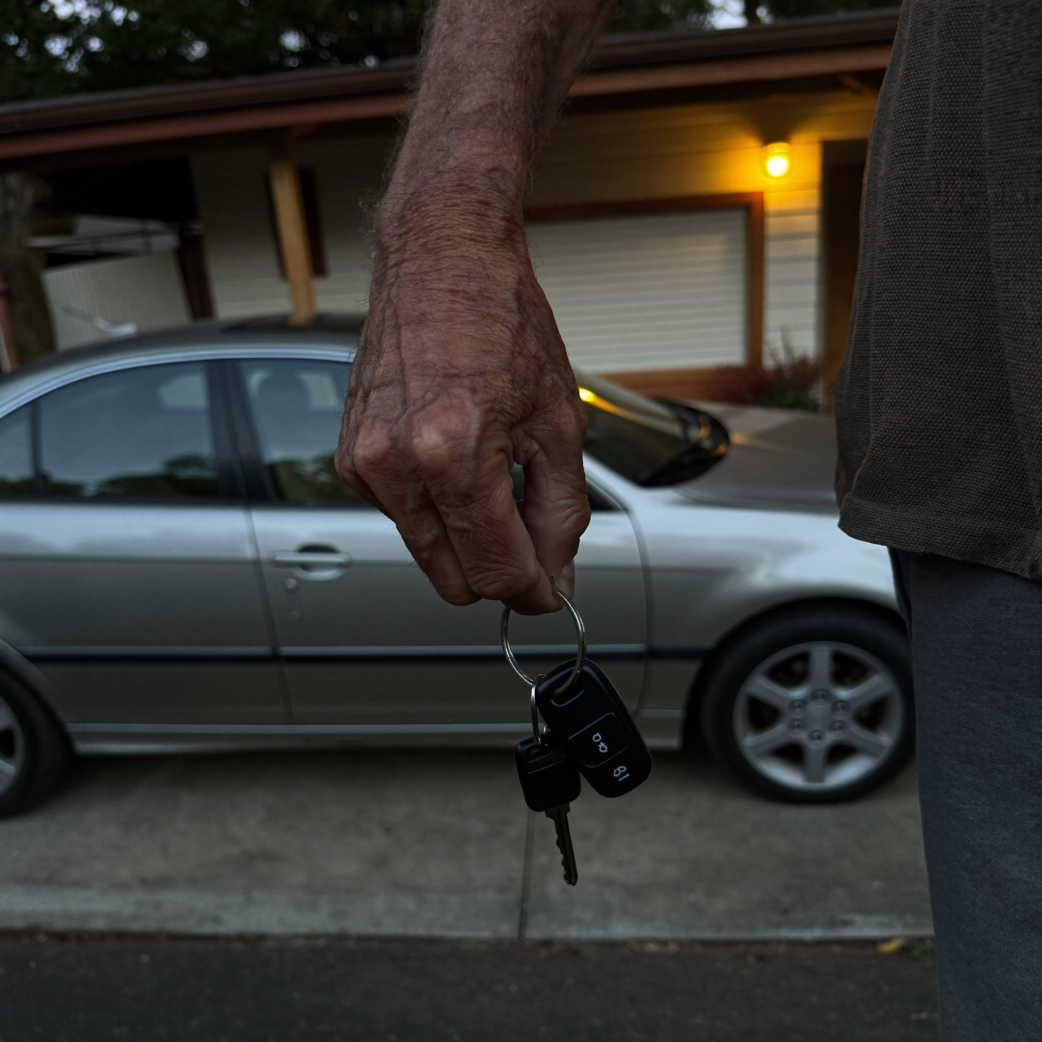 Car keys in hand at dusk