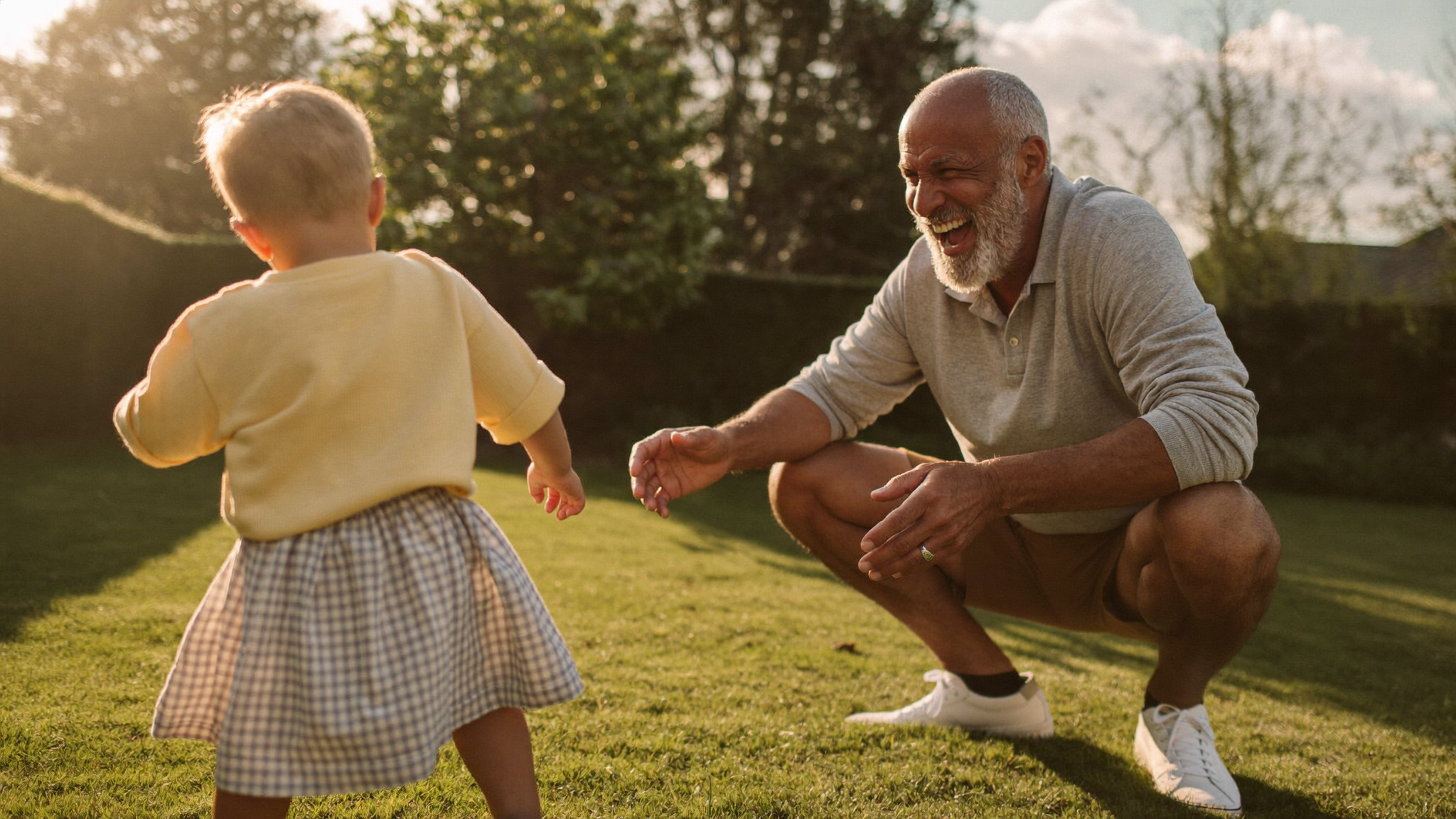 A grandfather in the garden with his grandchild