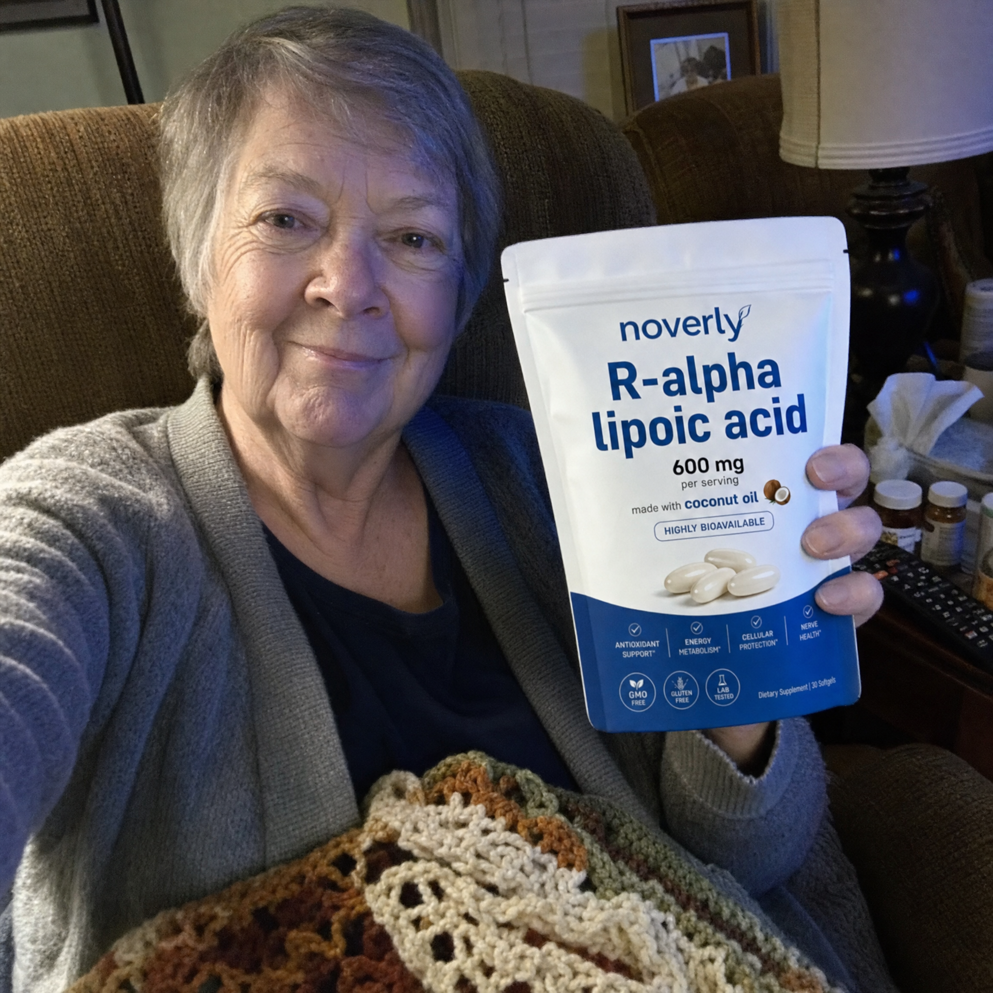 Customer in her living room holding the Noverly pouch