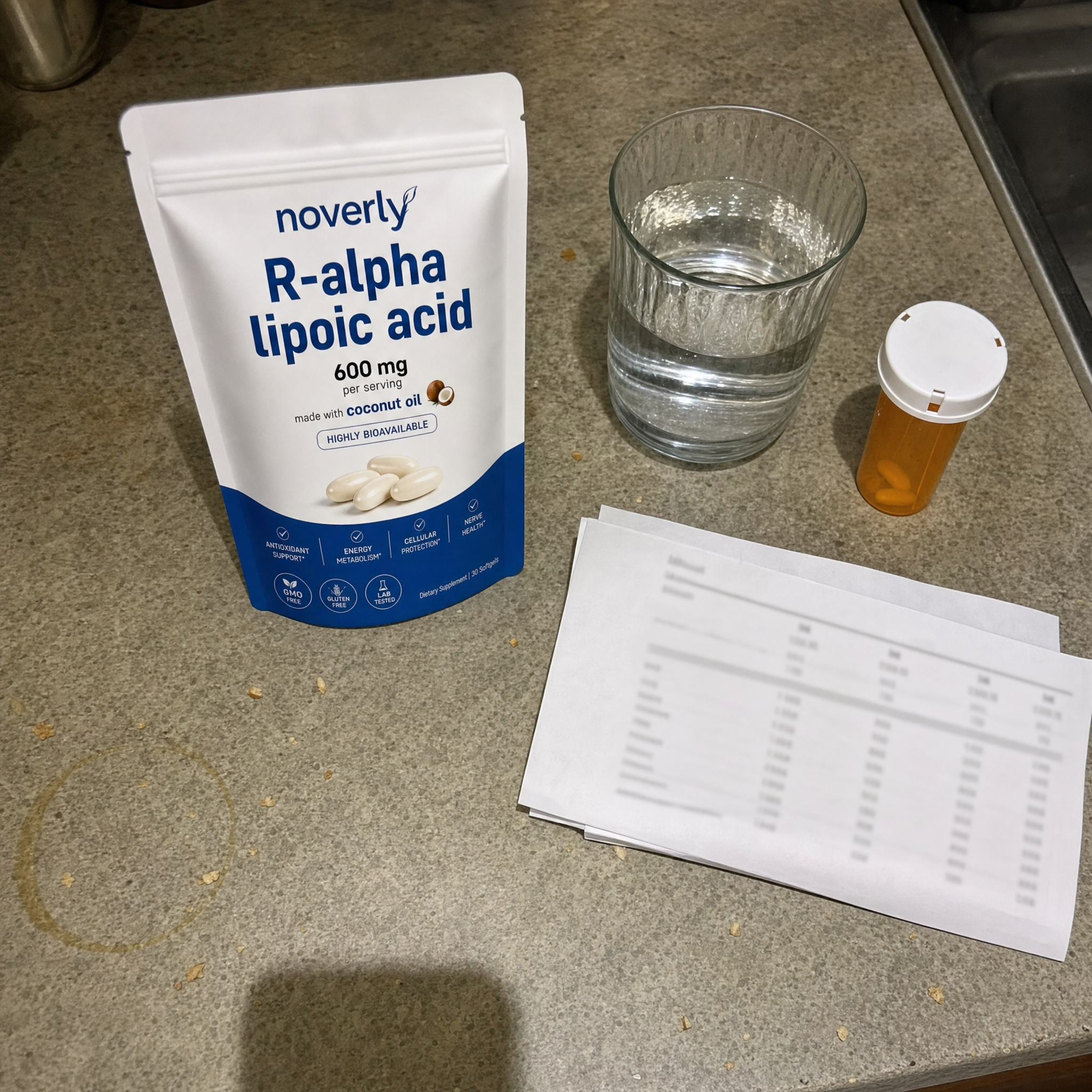 The Noverly pouch on a kitchen counter beside a glass of water, a prescription bottle and a clinic printout