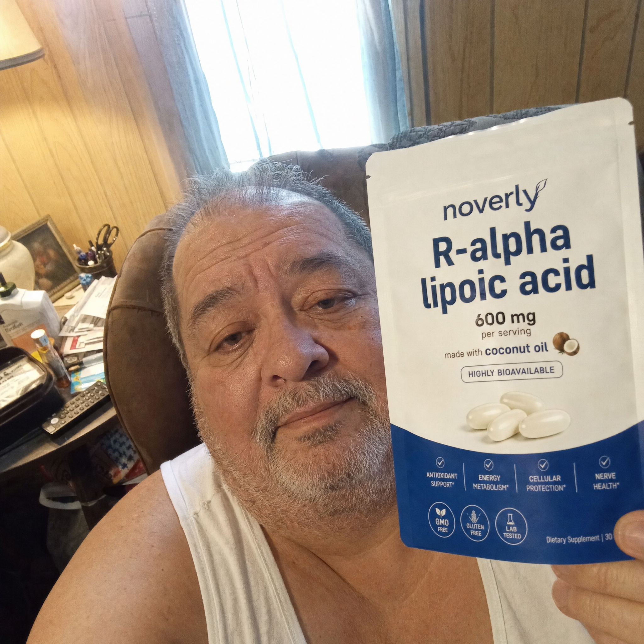 Customer in his living room holding the Noverly pouch
