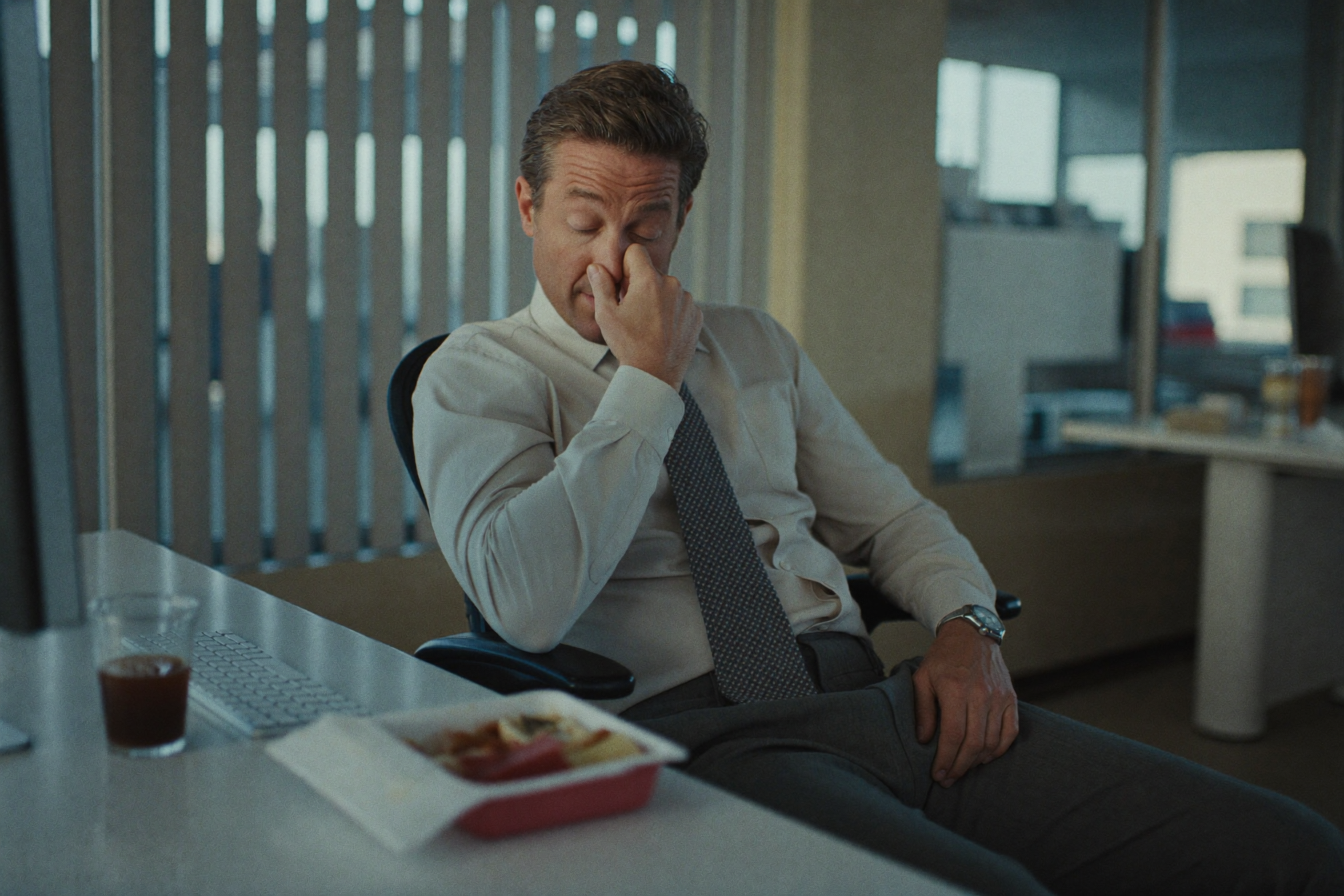 A man slumped at his desk in the mid-afternoon