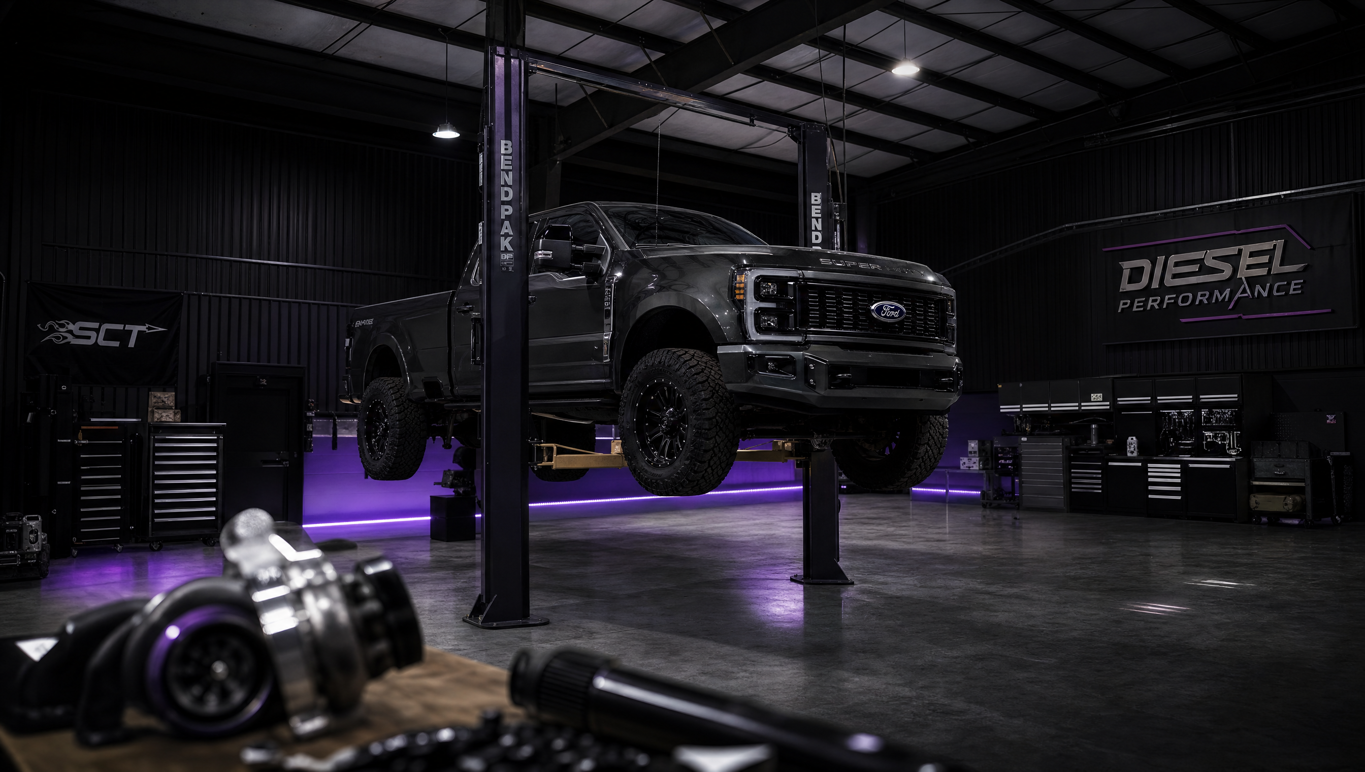 Affliction Diesel professional diesel truck repair shop interior with truck on lift