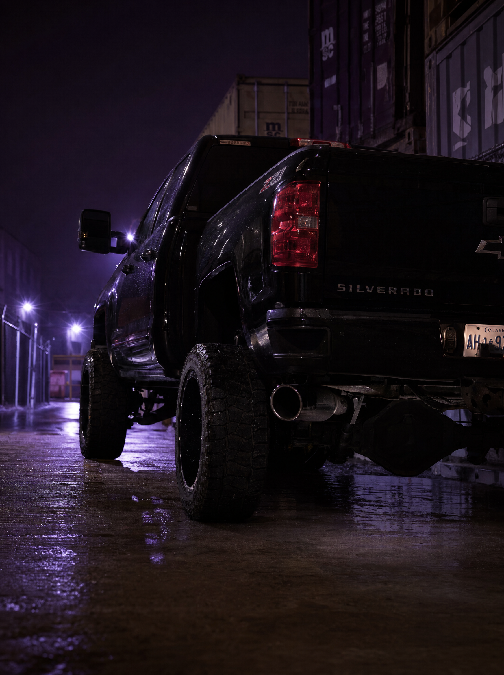 Modified Chevy Silverado 2500HD Duramax in an industrial alleyway at night
