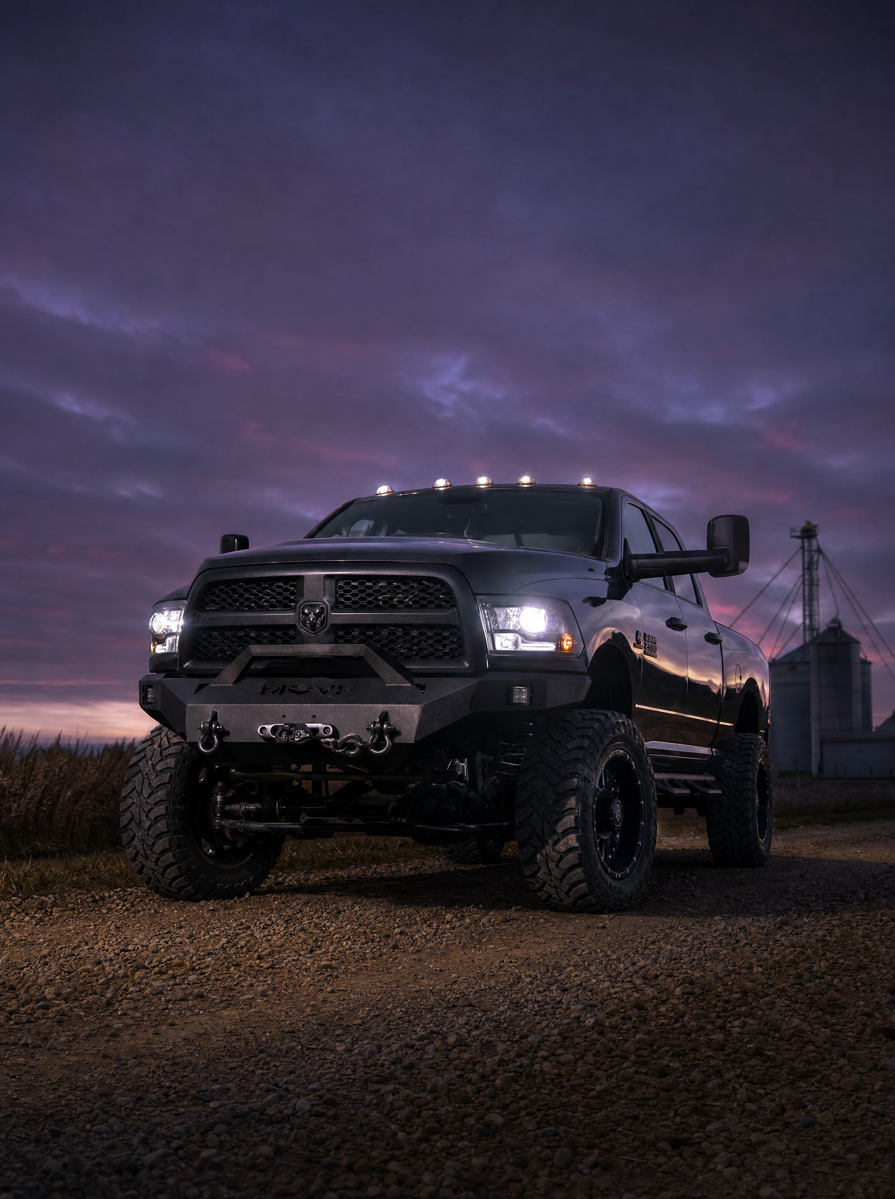Modified Dodge Ram 2500 Cummins on a rural gravel road at twilight