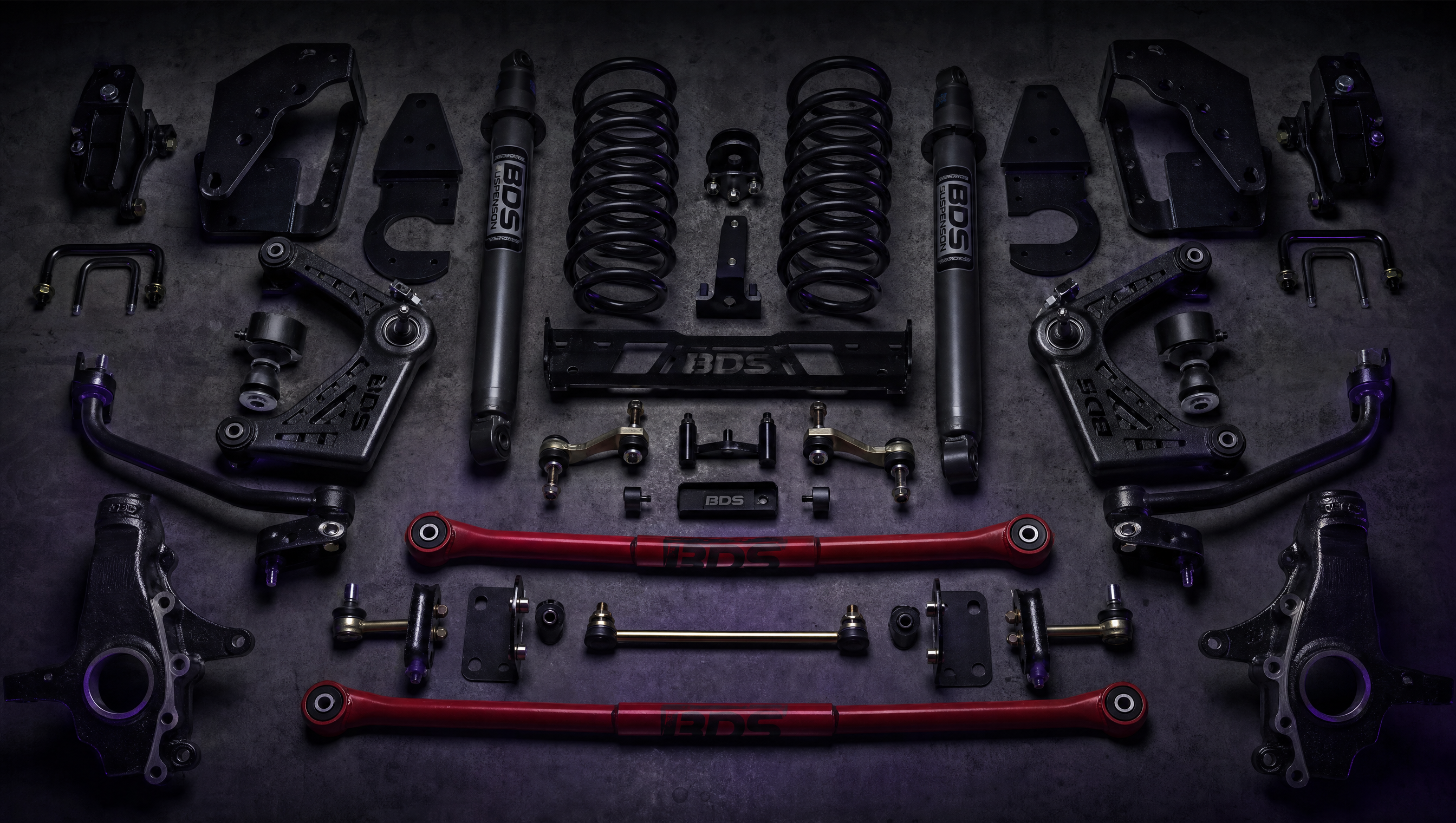 Collection of diesel truck suspension parts on dark surface