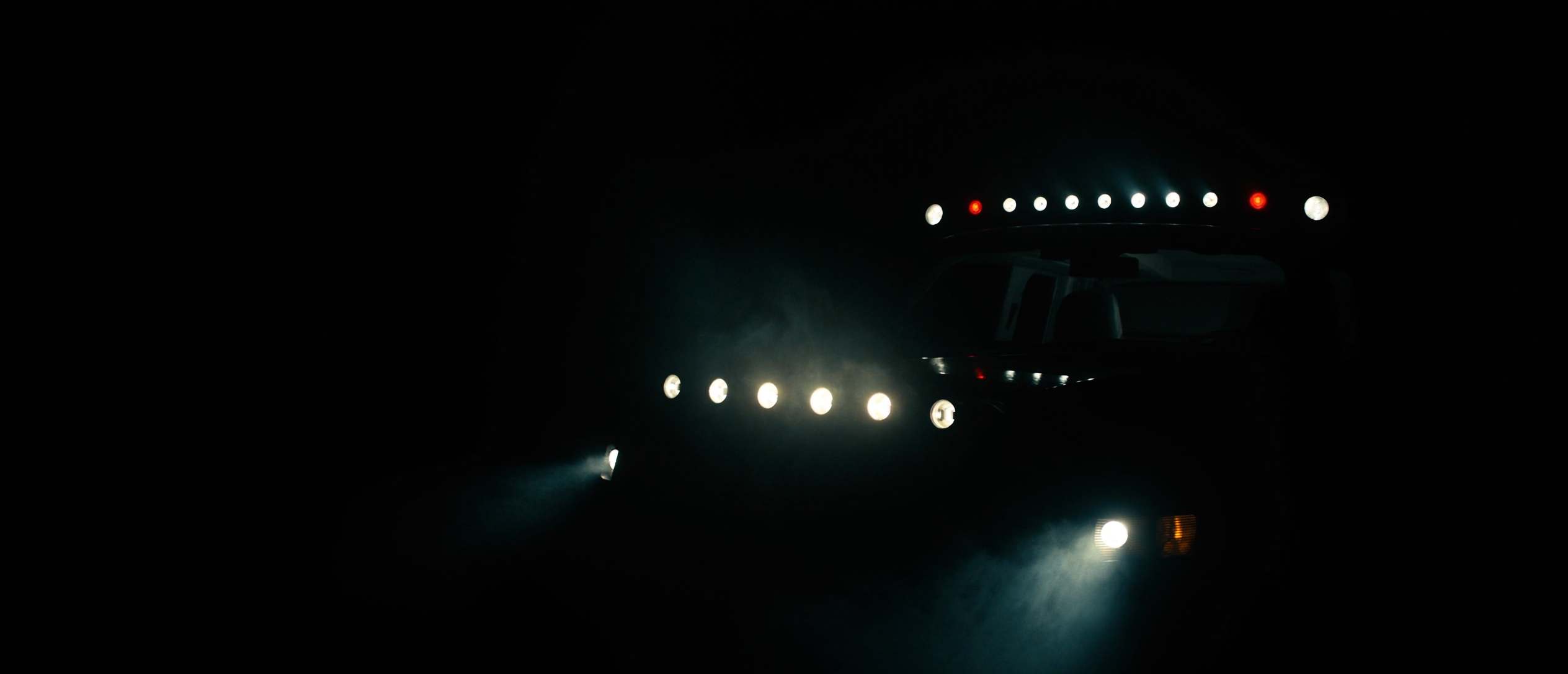LED light bars and pod lights cutting beams through darkness