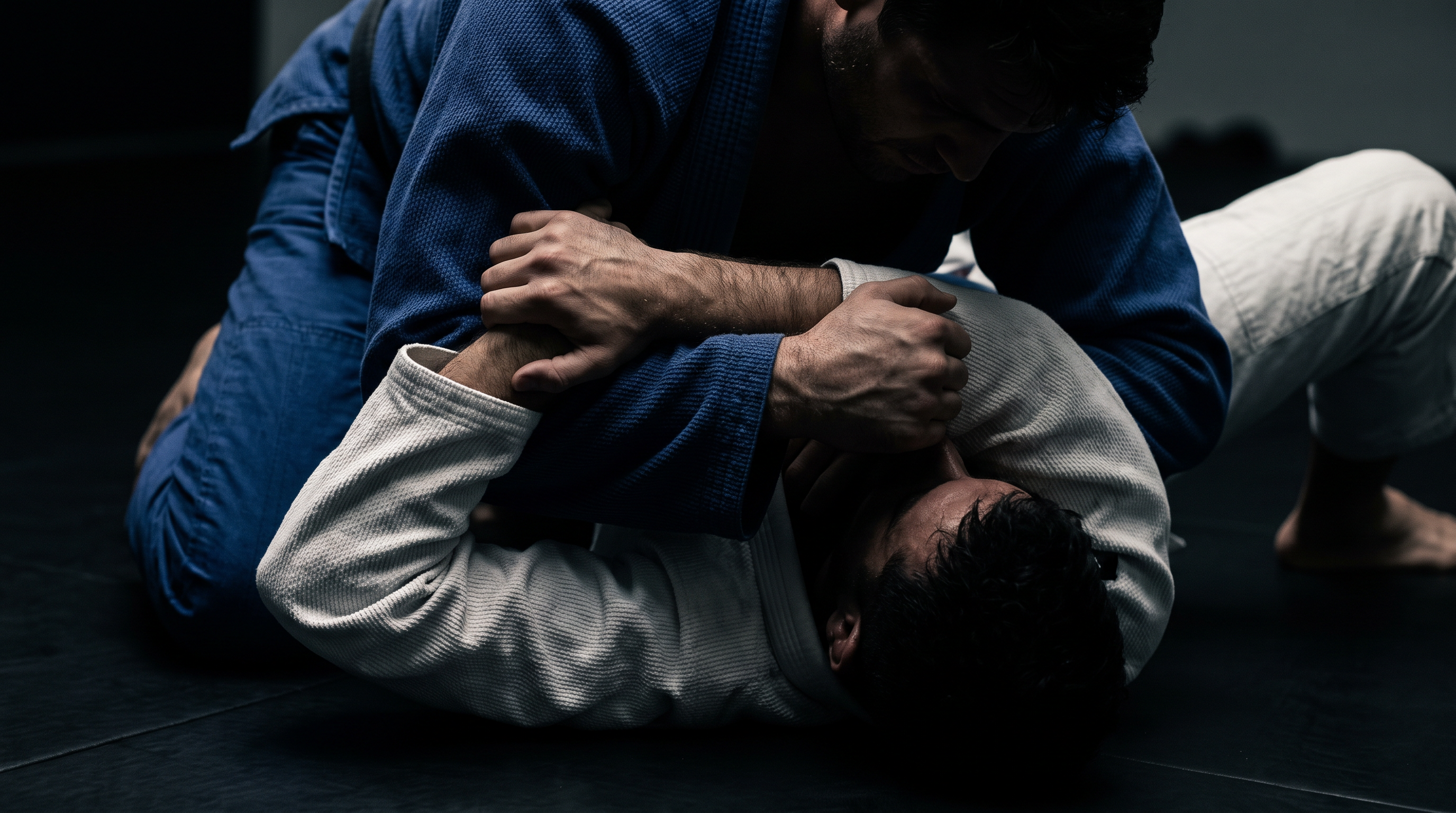 A BJJ practitioner in mount setting up an Ezekiel choke, with one arm under the head and the other forming a figure-four grip across the neck.