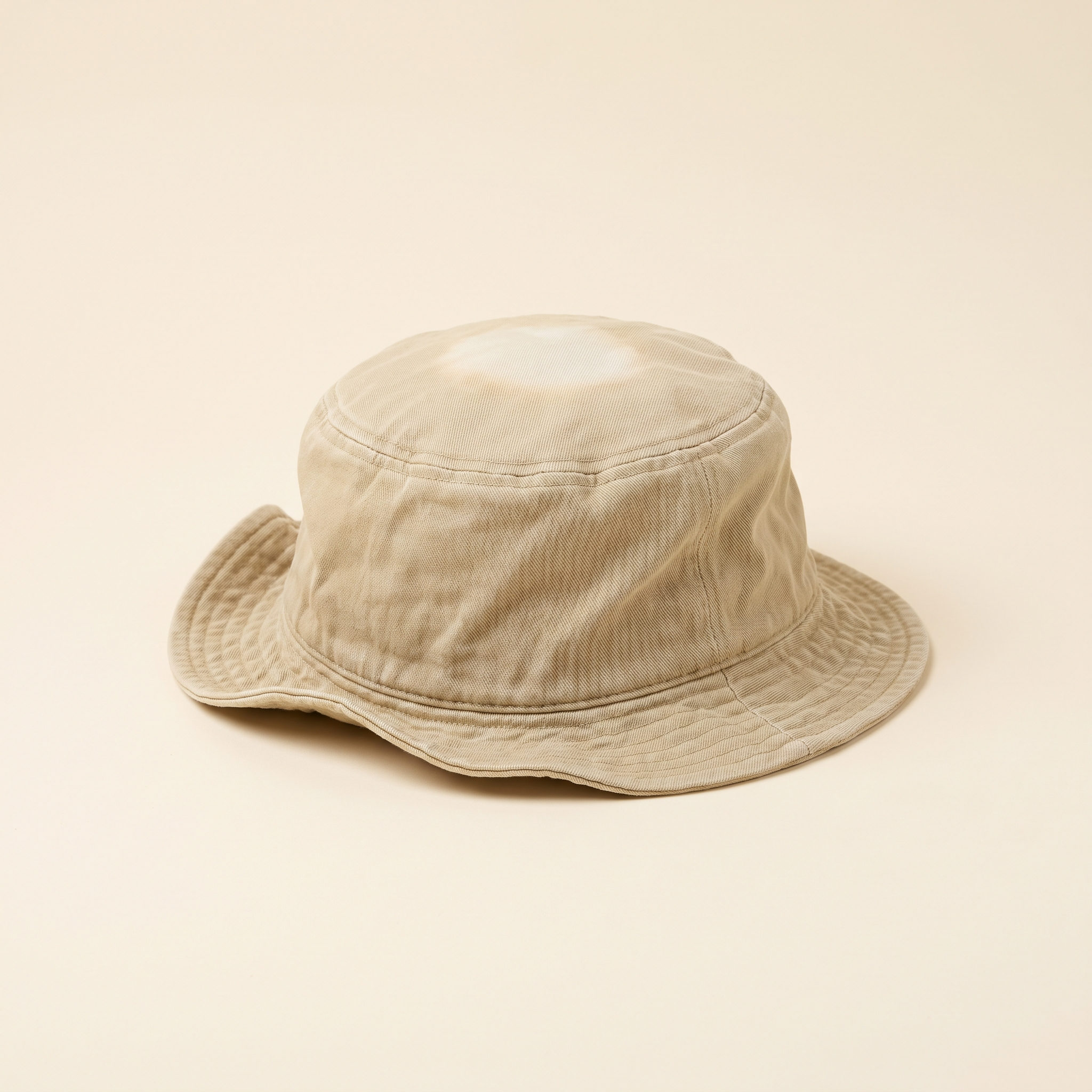 A crumpled beige bucket hat