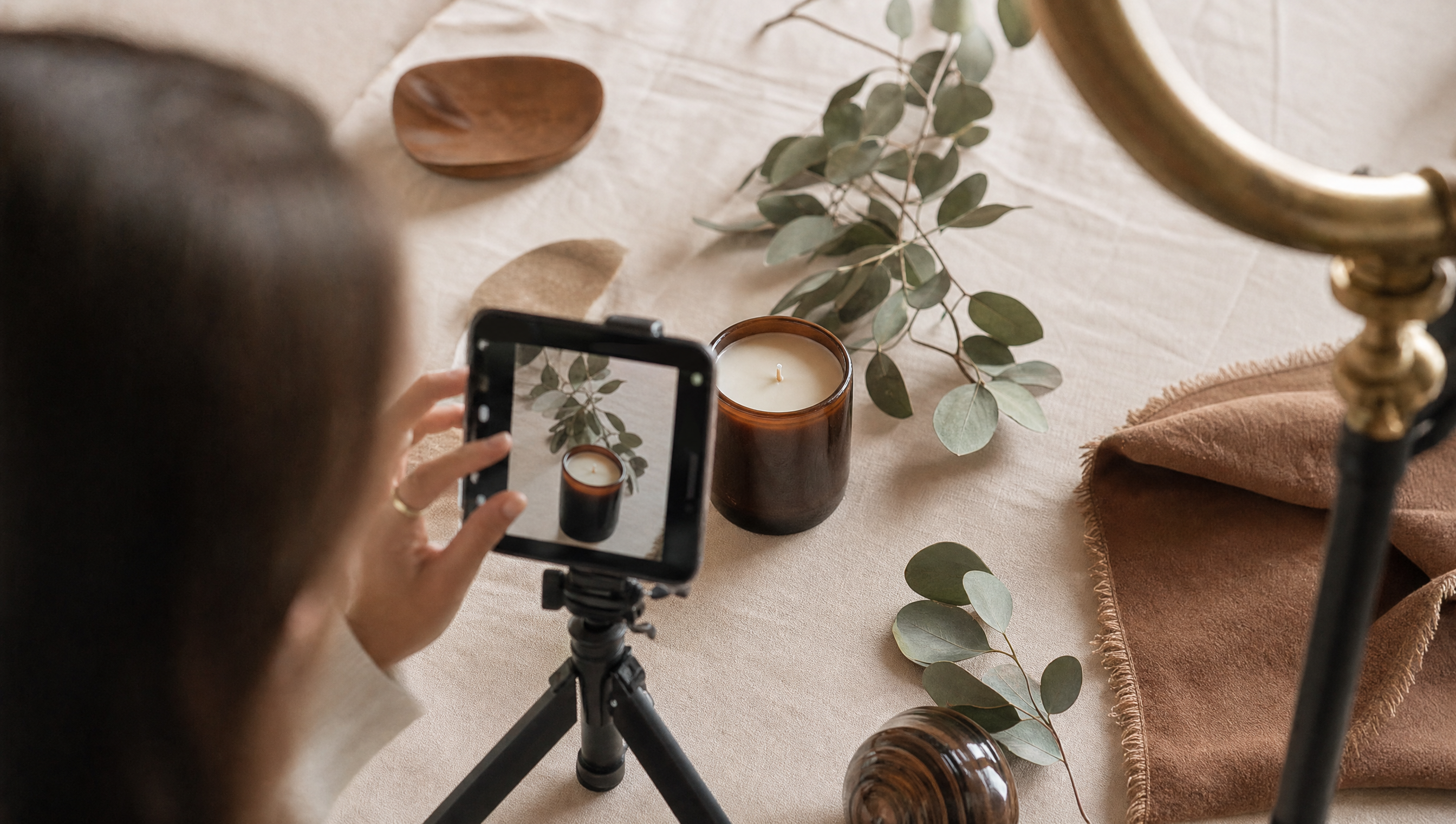 A boutique brand social media shoot in Marin County, styling an artisan candle with a phone on a tripod and ring light