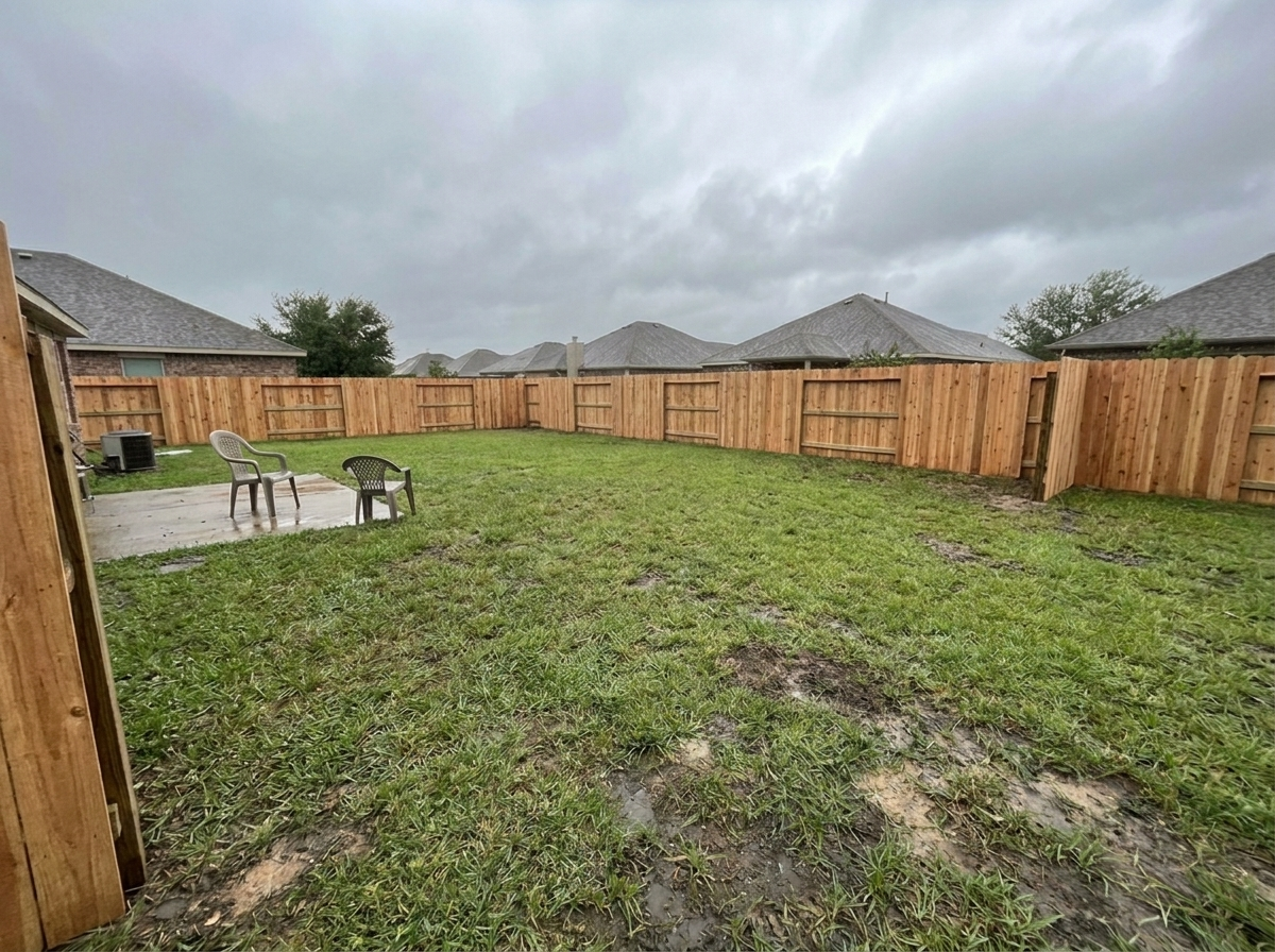 Rebuilt board-on-board cedar fence standing straight