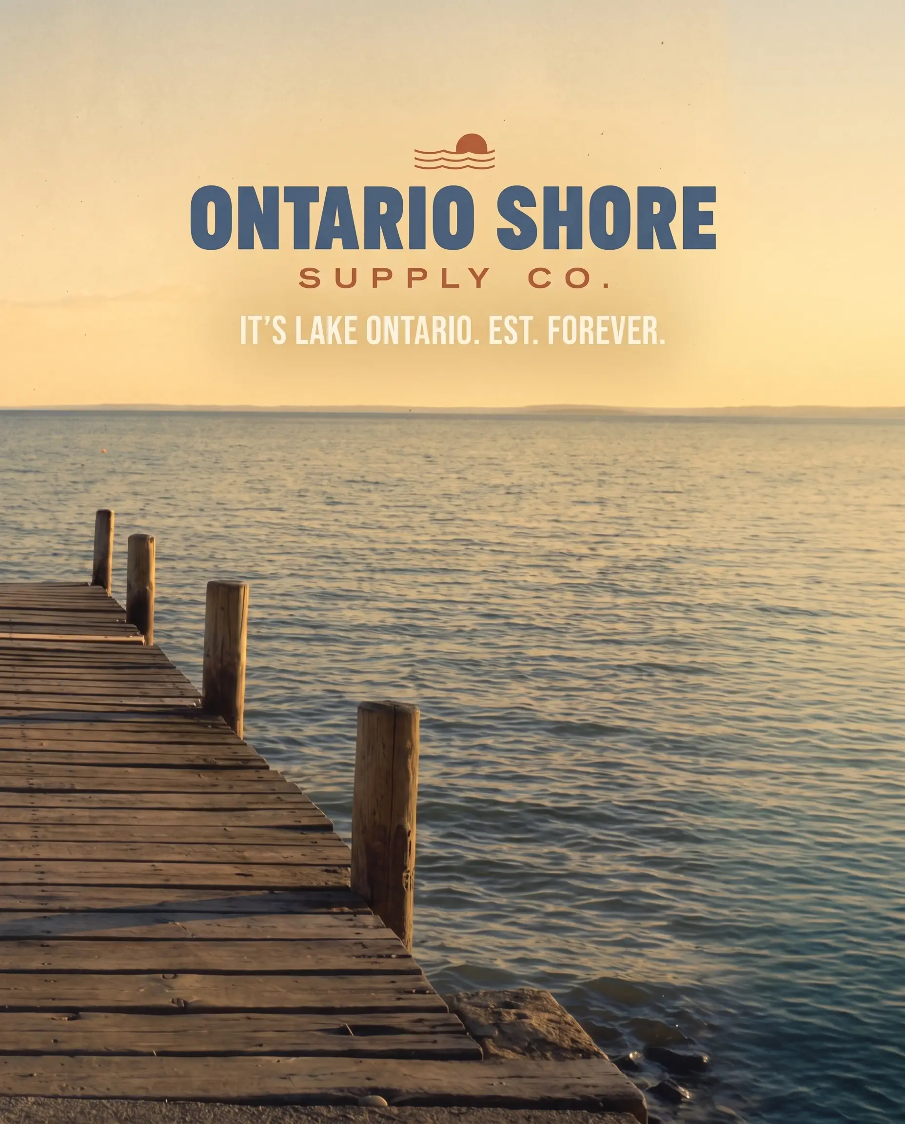Ontario Shore Supply Co. — It's Lake Ontario. Est. forever. Wooden dock on Lake Ontario at golden hour
