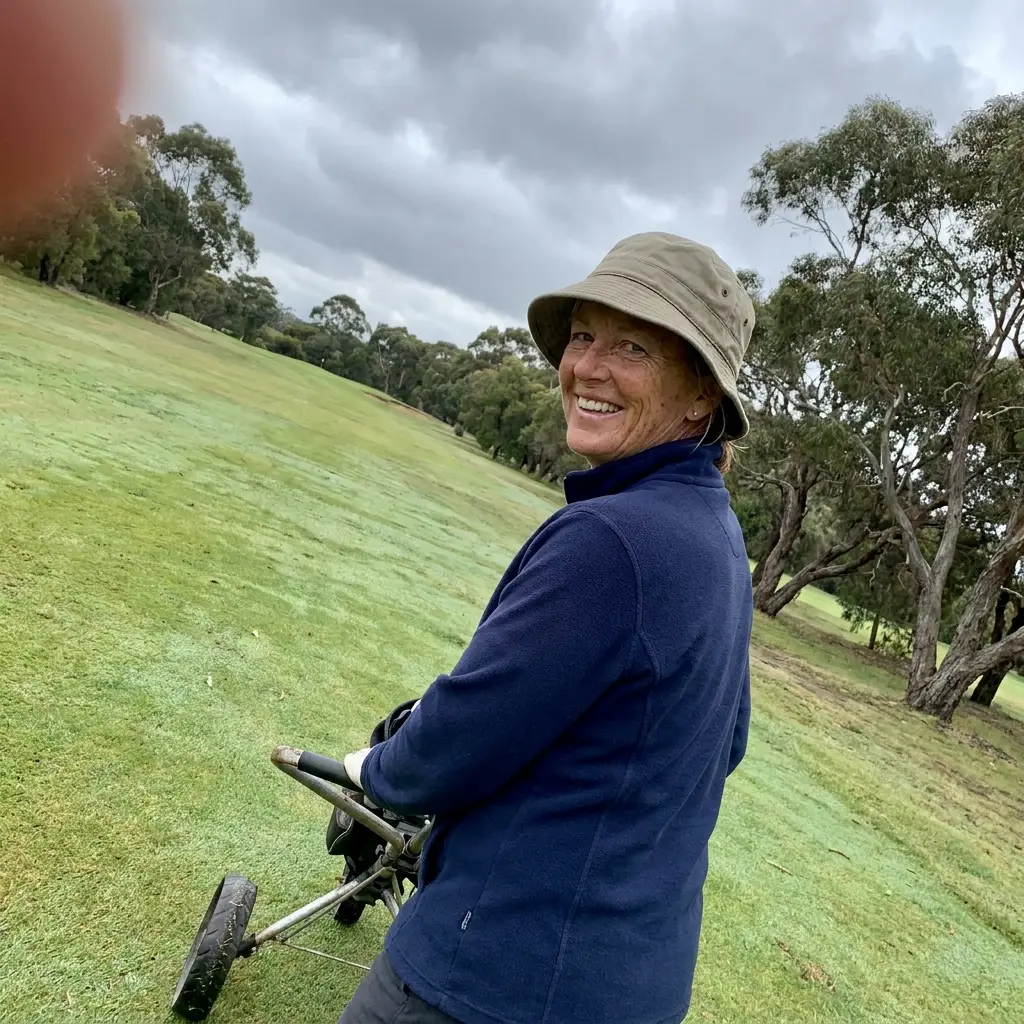 Judy pulling her buggy up the fairway