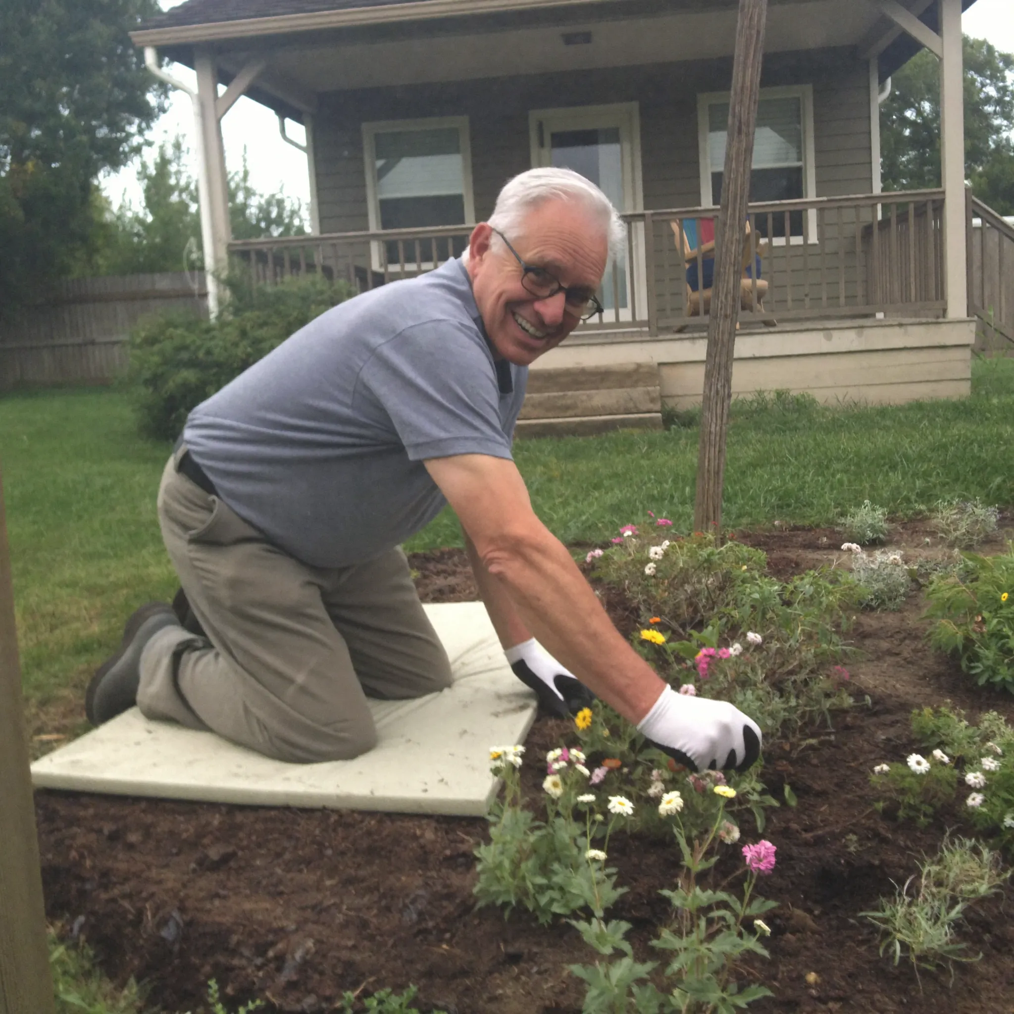 Tom kneeling in his flower bed