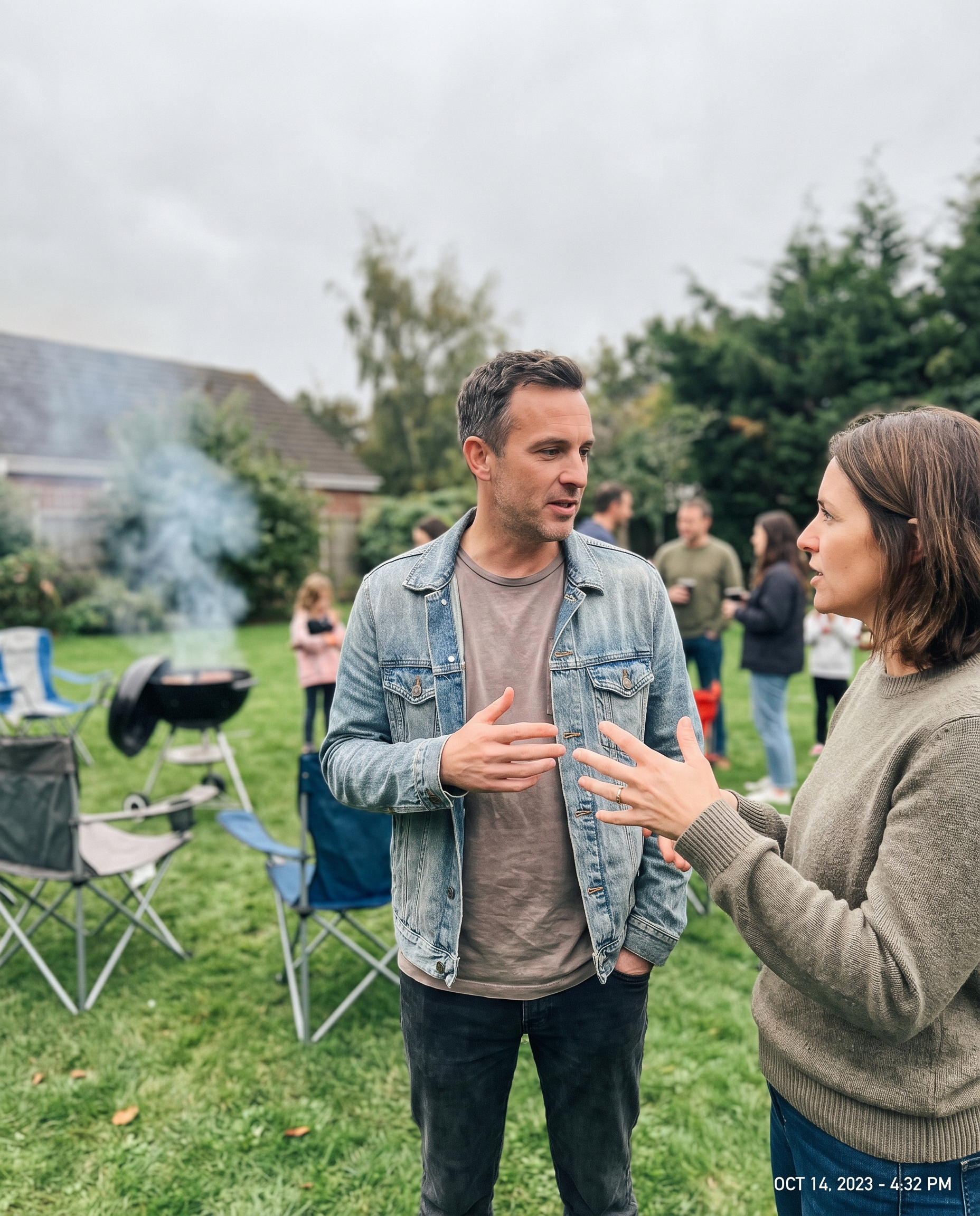 Two people talking candidly outdoors at a backyard gathering