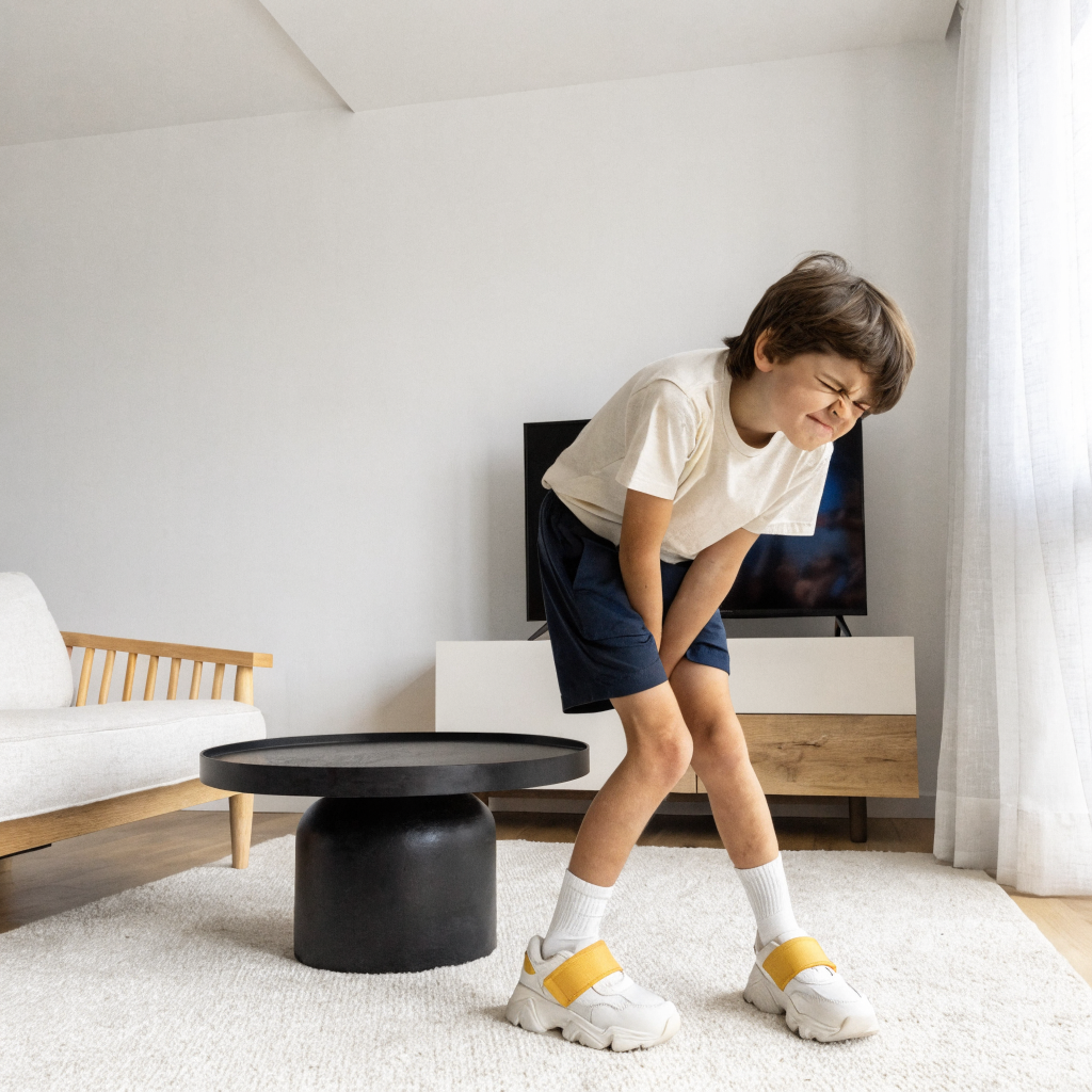 A child doing the wiggle dance and insisting he does not need to go