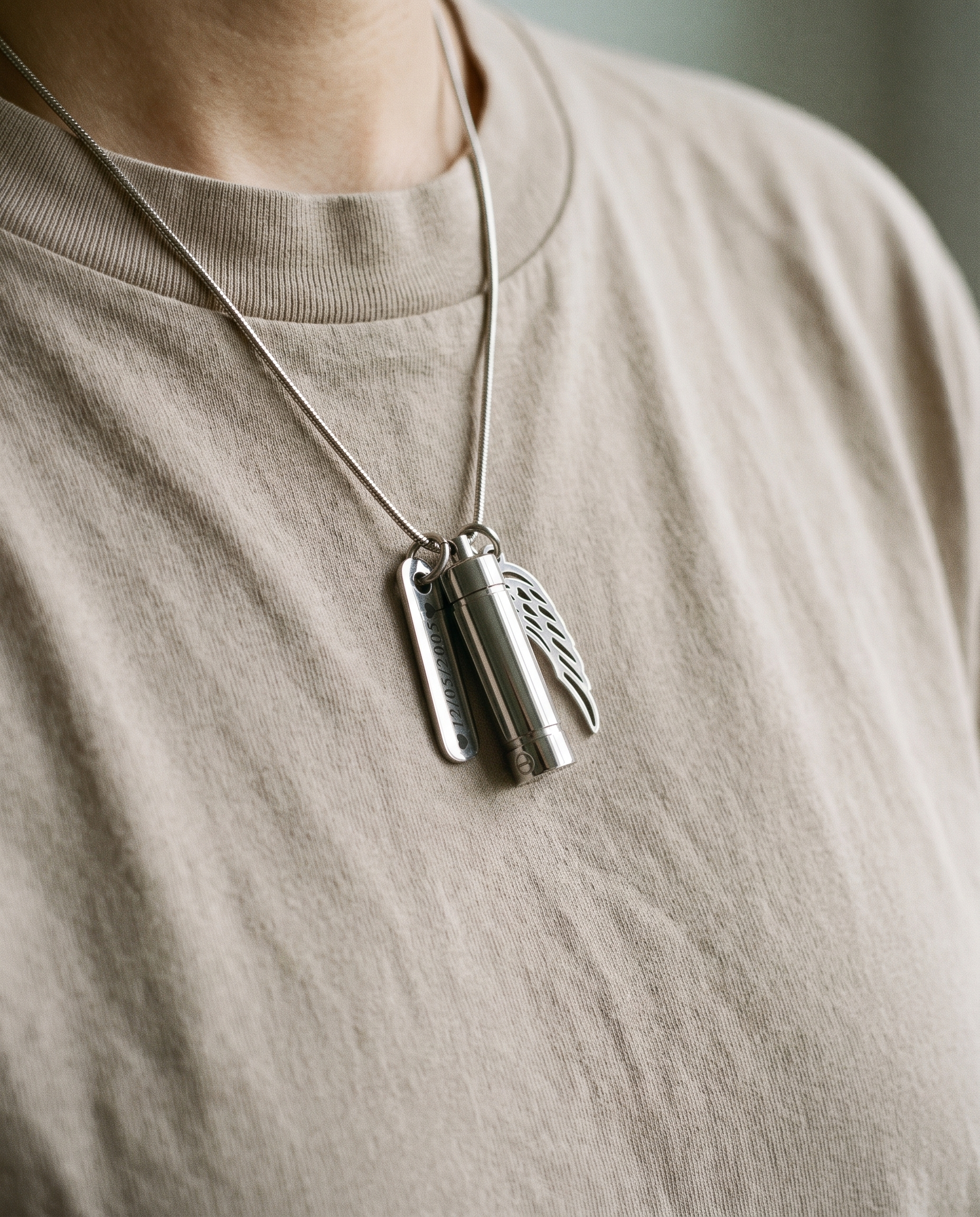 Hand resting over a memorial keepsake pendant worn close to the heart