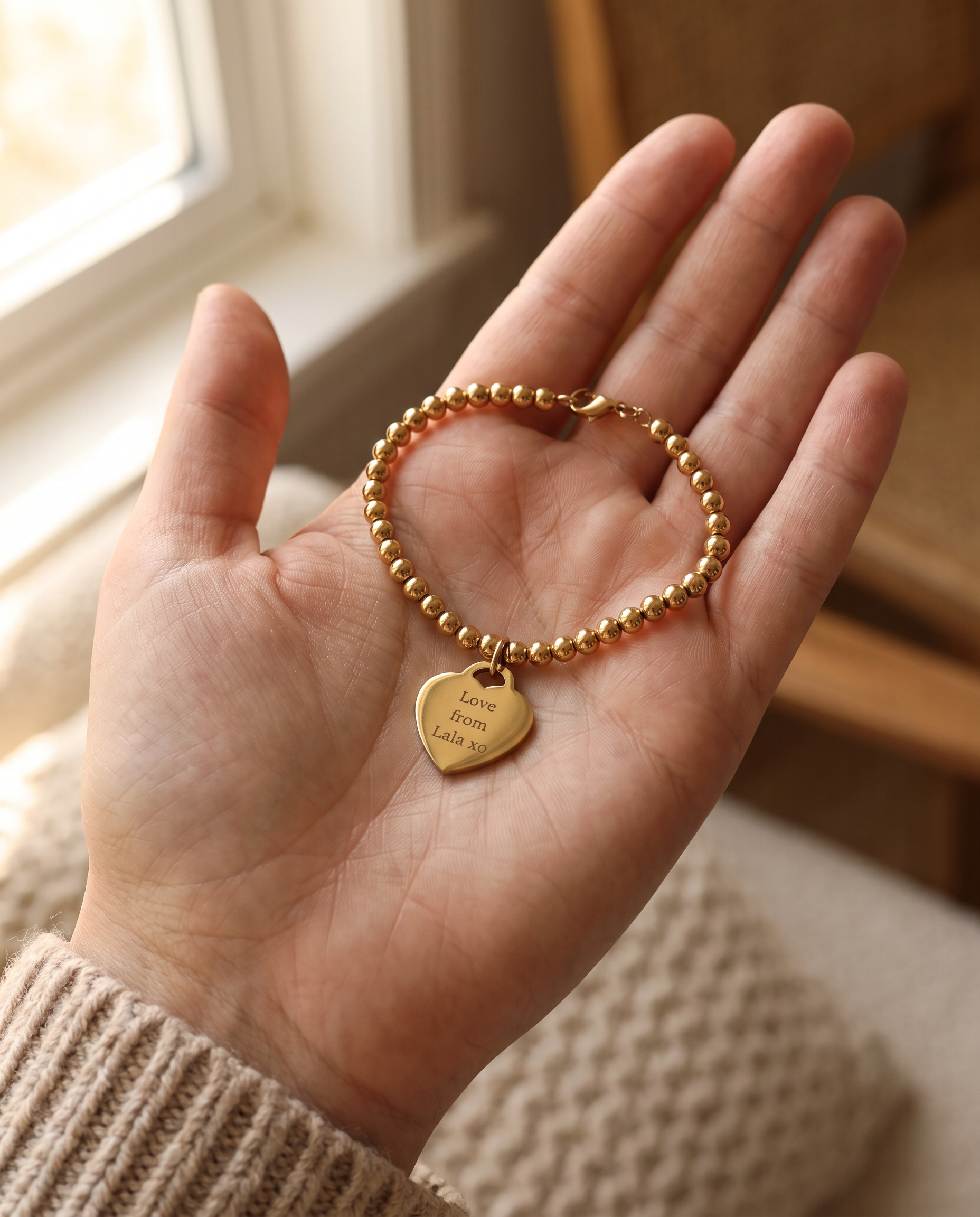 Silver tone and rose gold tone engraved pendants laid on a pale linen surface