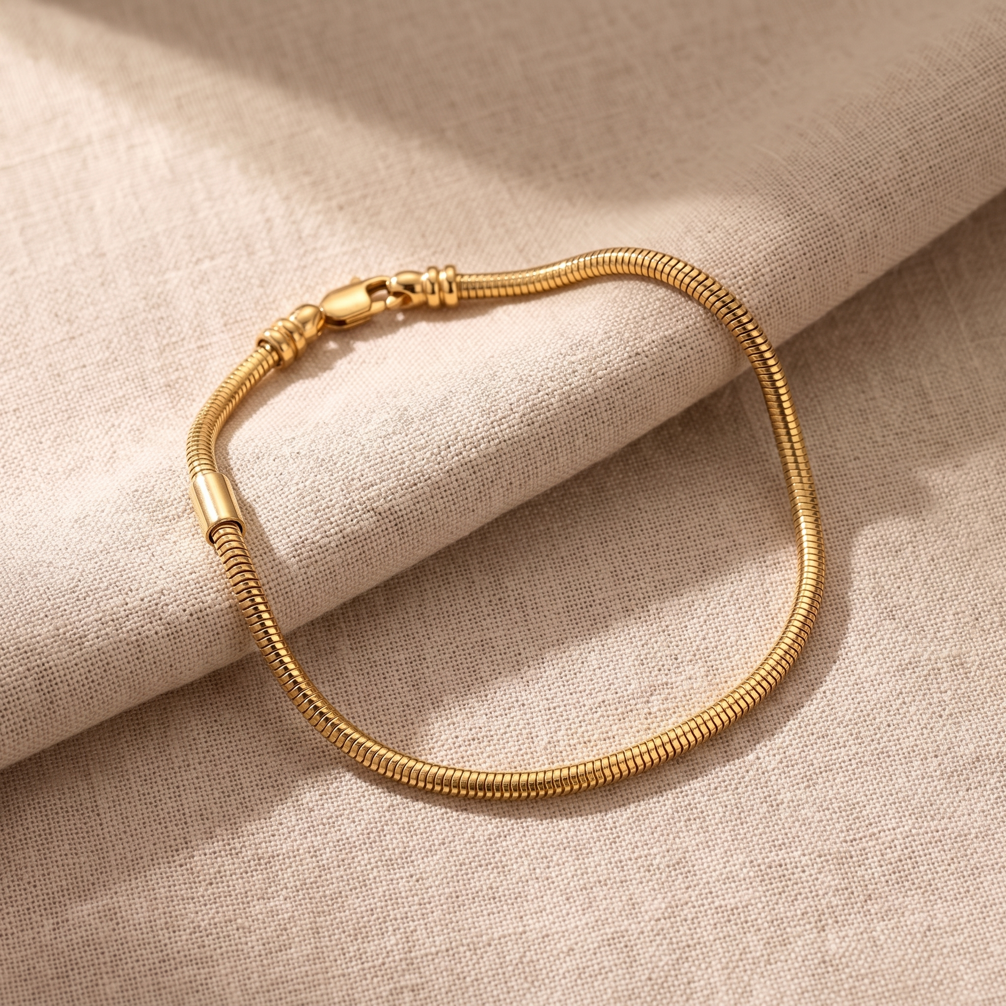 A finished charm bracelet resting beside a scattering of practice blanks