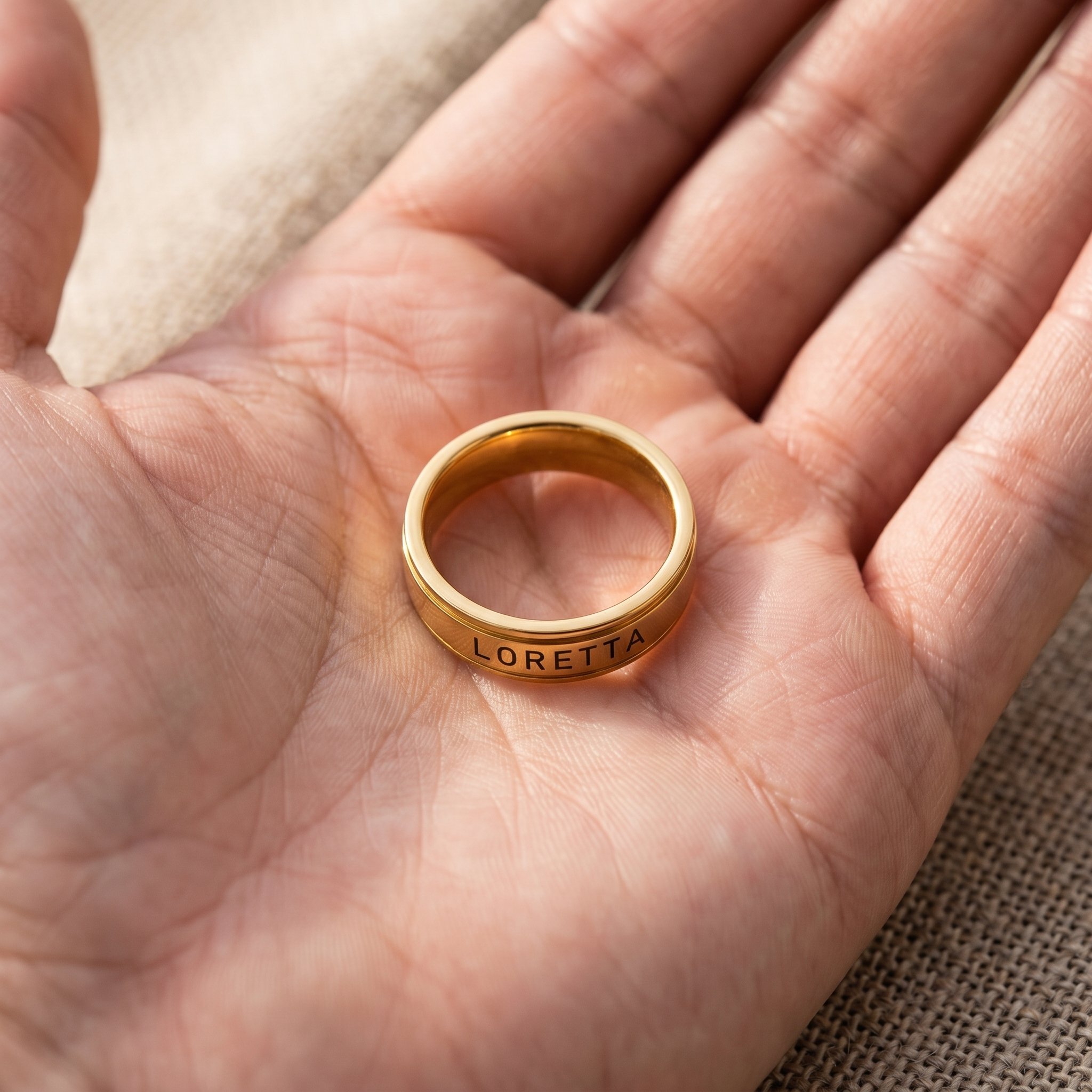 A plain band worn beside a second engraved ring on the same finger