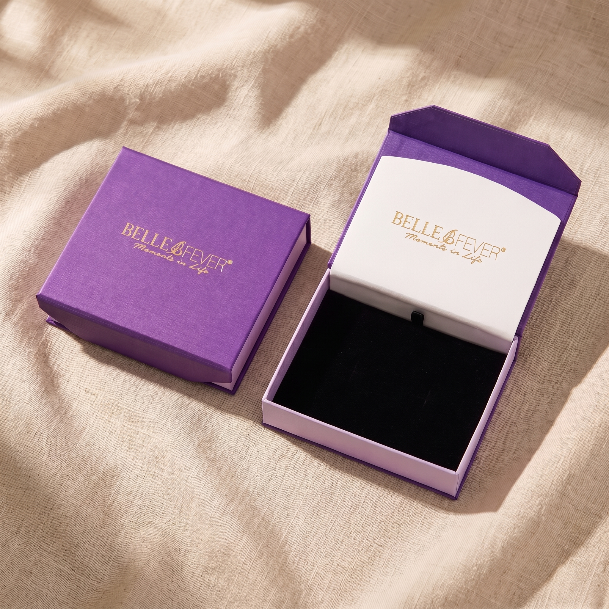 An open lined jewellery box with pieces separated into compartments